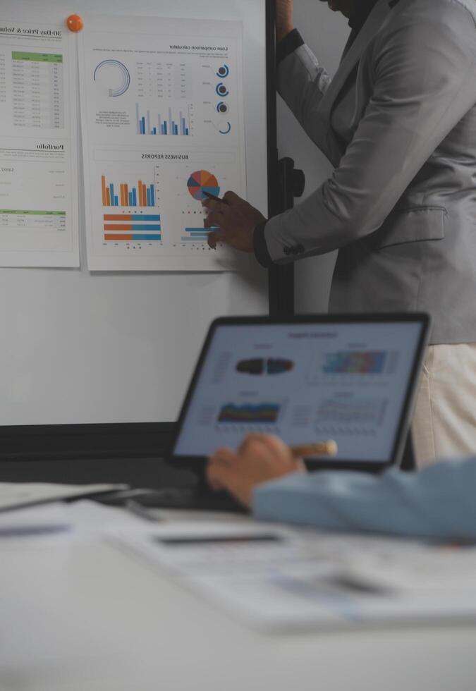 Close up of Business team analyzing income charts and graphs with modern laptop computer. Business analysis and strategy concept. photo