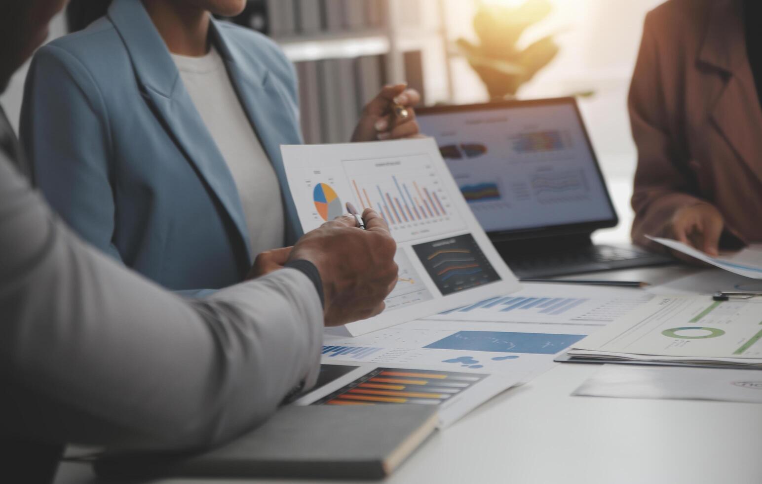 Close up of Business team analyzing income charts and graphs with modern laptop computer. Business analysis and strategy concept. photo