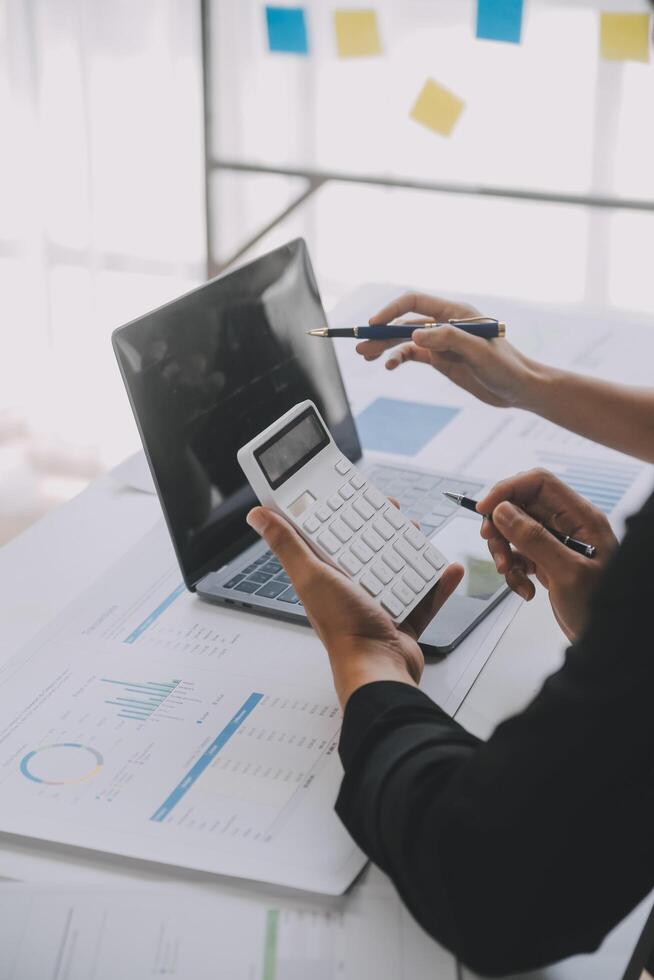 Financial analysts analyze business financial reports on a digital tablet planning investment project during a discussion at a meeting of corporate showing the results of their successful teamwork. photo