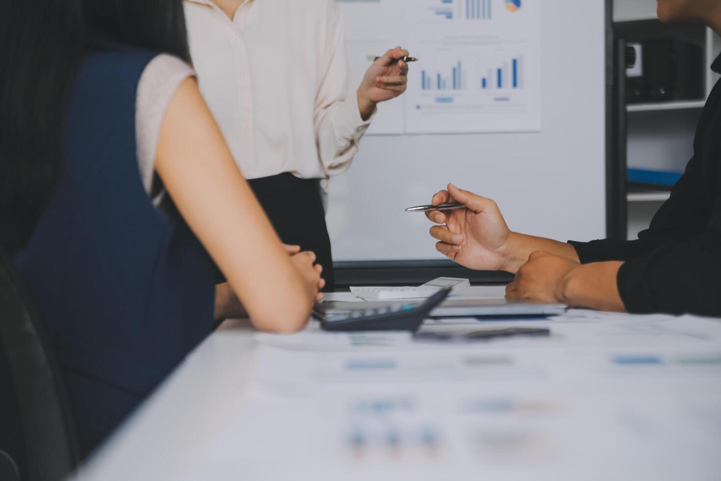 Financial analysts analyze business financial reports on a digital tablet planning investment project during a discussion at a meeting of corporate showing the results of their successful teamwork. photo