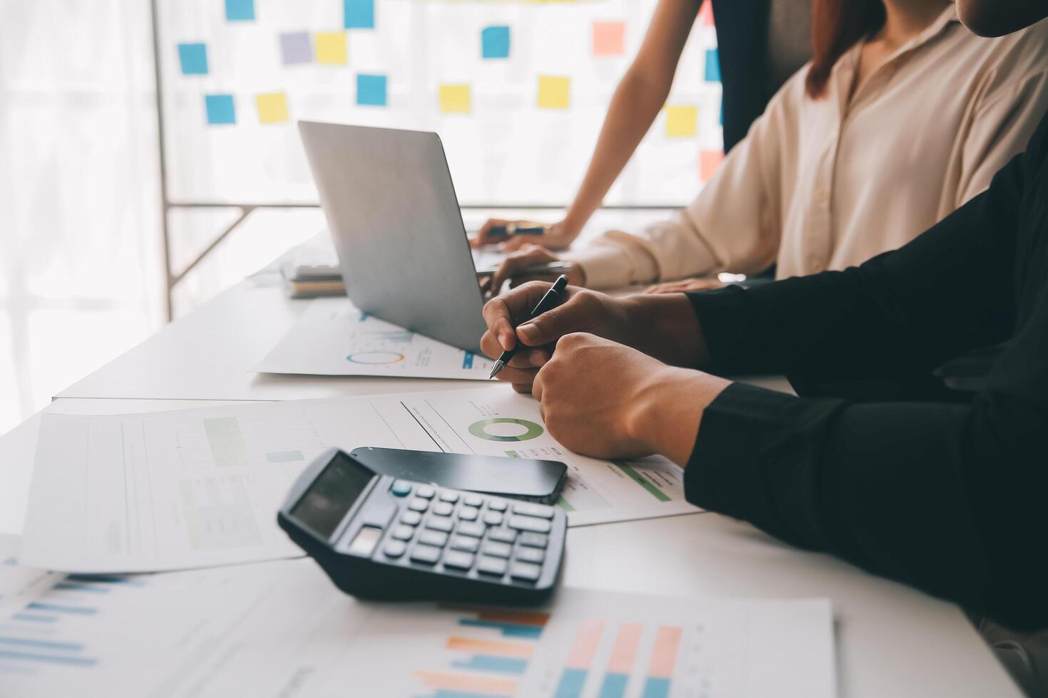 Financial analysts analyze business financial reports on a digital tablet planning investment project during a discussion at a meeting of corporate showing the results of their successful teamwork. photo