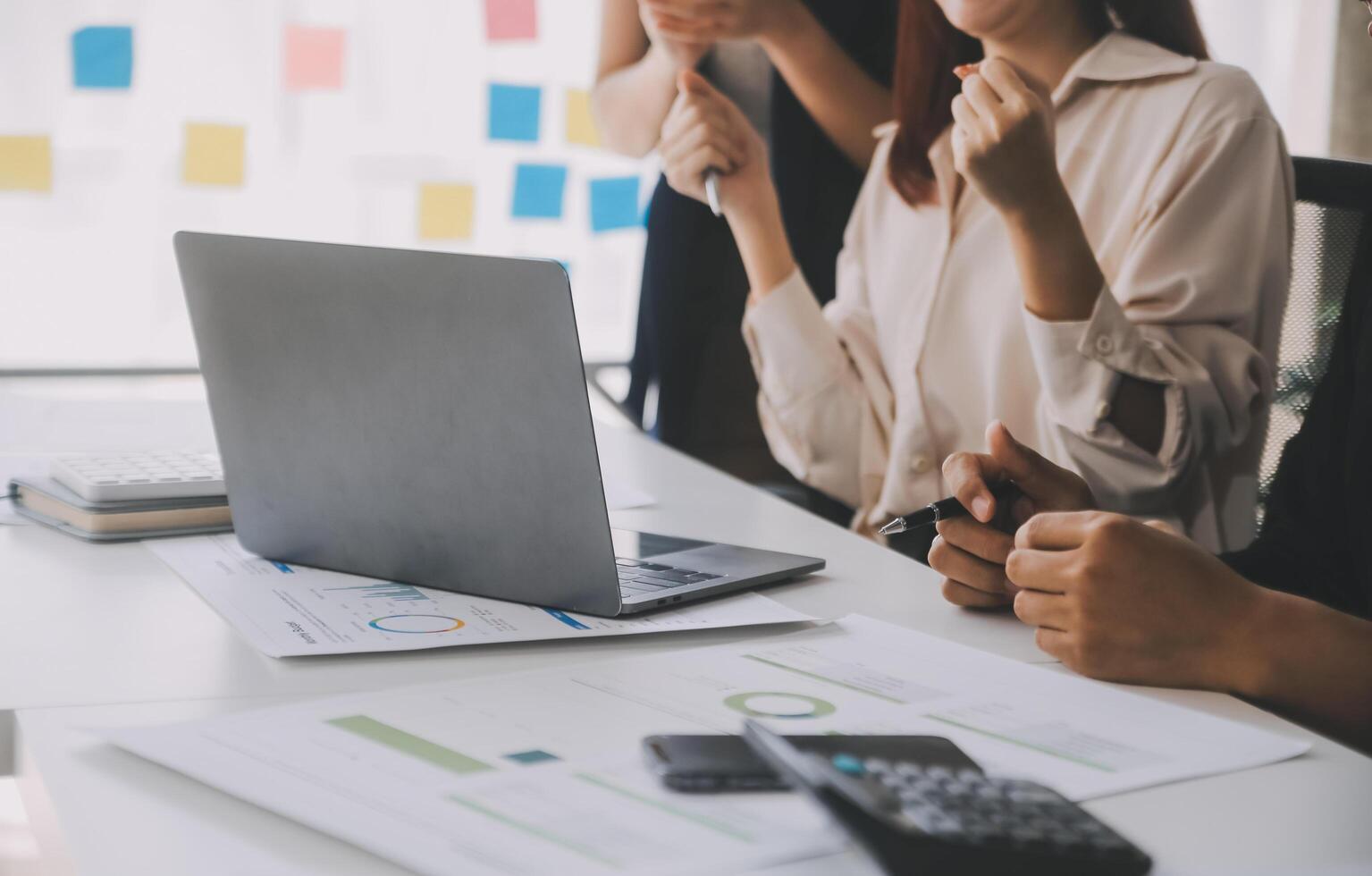 Financial analysts analyze business financial reports on a digital tablet planning investment project during a discussion at a meeting of corporate showing the results of their successful teamwork. photo