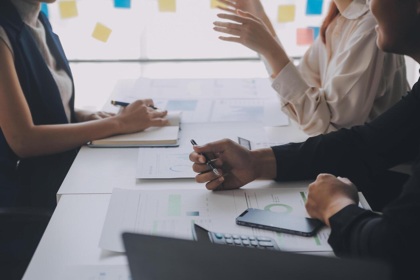 Financial analysts analyze business financial reports on a digital tablet planning investment project during a discussion at a meeting of corporate showing the results of their successful teamwork. photo