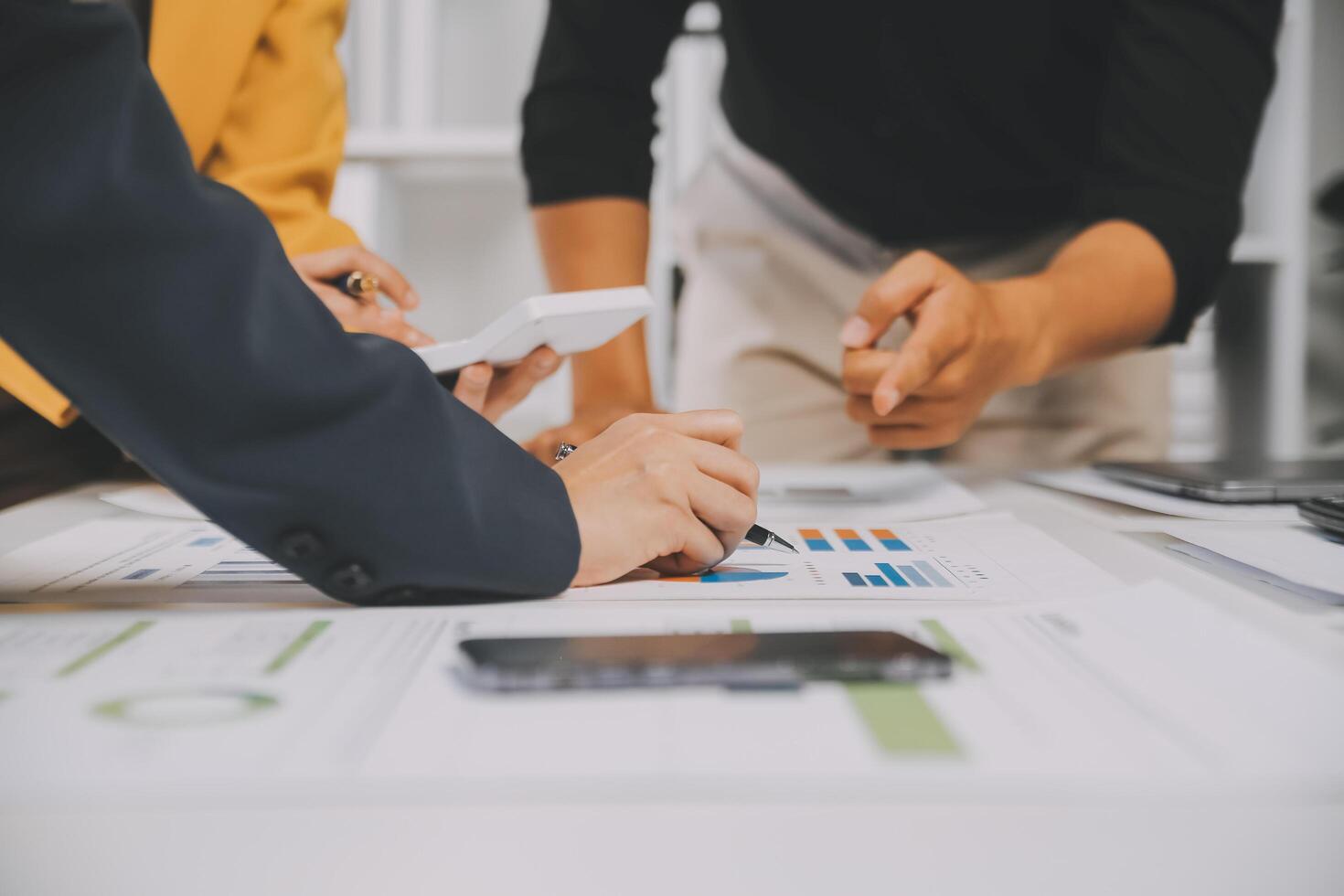 Financial analysts analyze business financial reports on a digital tablet planning investment project during a discussion at a meeting of corporate showing the results of their successful teamwork. photo