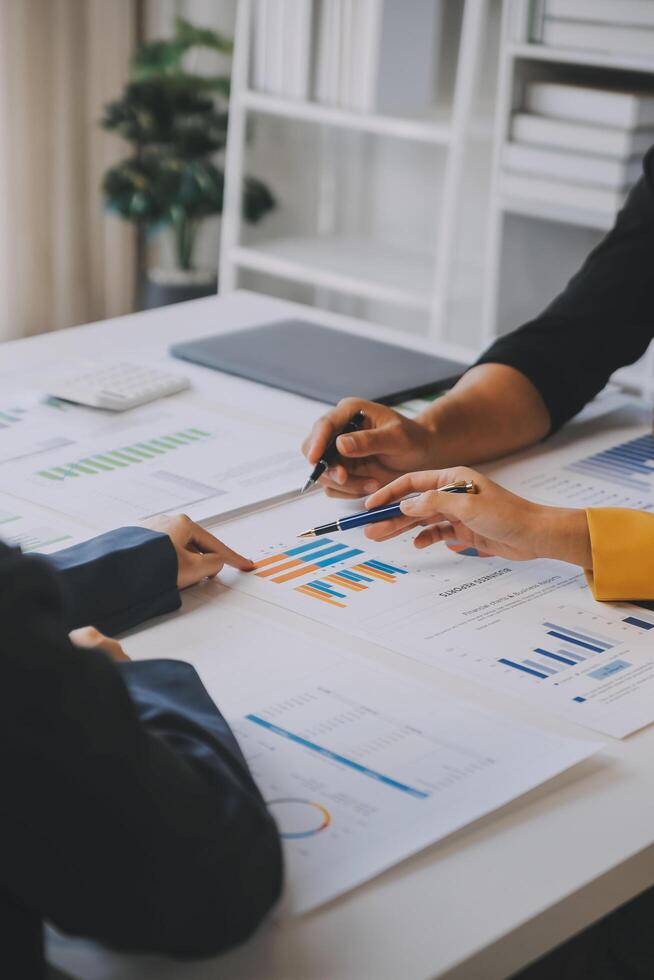 Financial analysts analyze business financial reports on a digital tablet planning investment project during a discussion at a meeting of corporate showing the results of their successful teamwork. photo