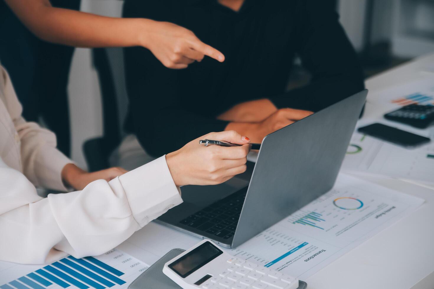 Financial analysts analyze business financial reports on a digital tablet planning investment project during a discussion at a meeting of corporate showing the results of their successful teamwork. photo