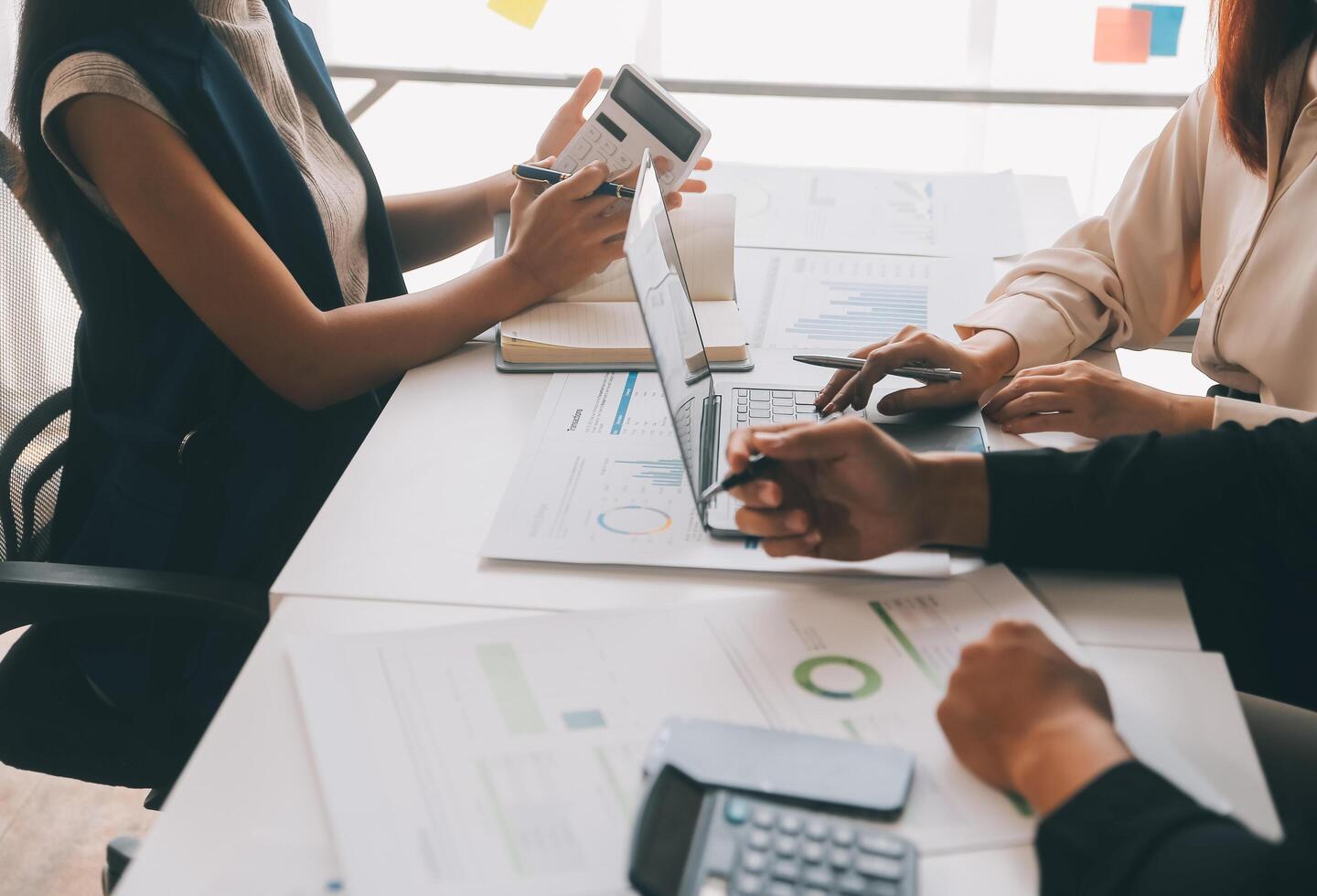 Financial analysts analyze business financial reports on a digital tablet planning investment project during a discussion at a meeting of corporate showing the results of their successful teamwork. photo