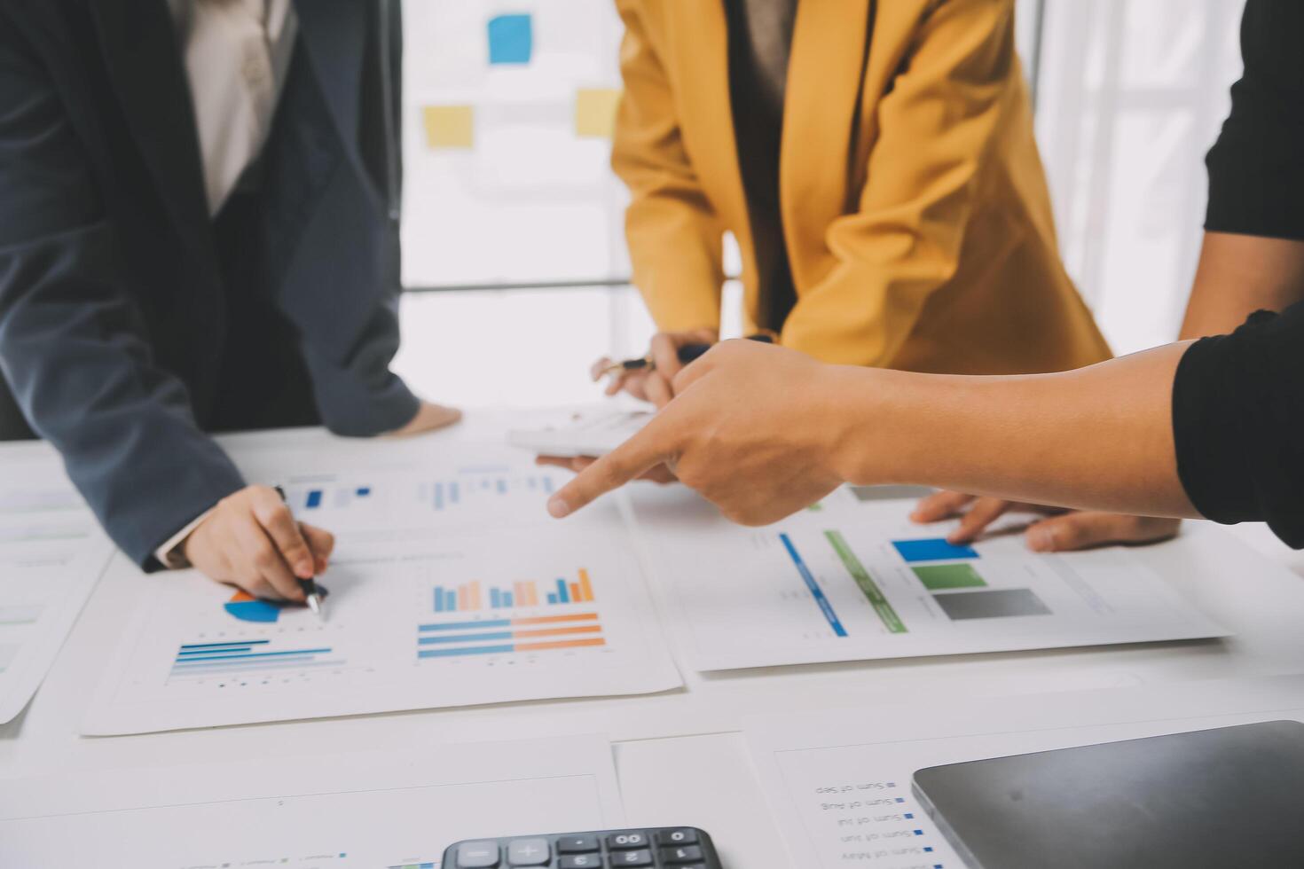 Financial analysts analyze business financial reports on a digital tablet planning investment project during a discussion at a meeting of corporate showing the results of their successful teamwork. photo