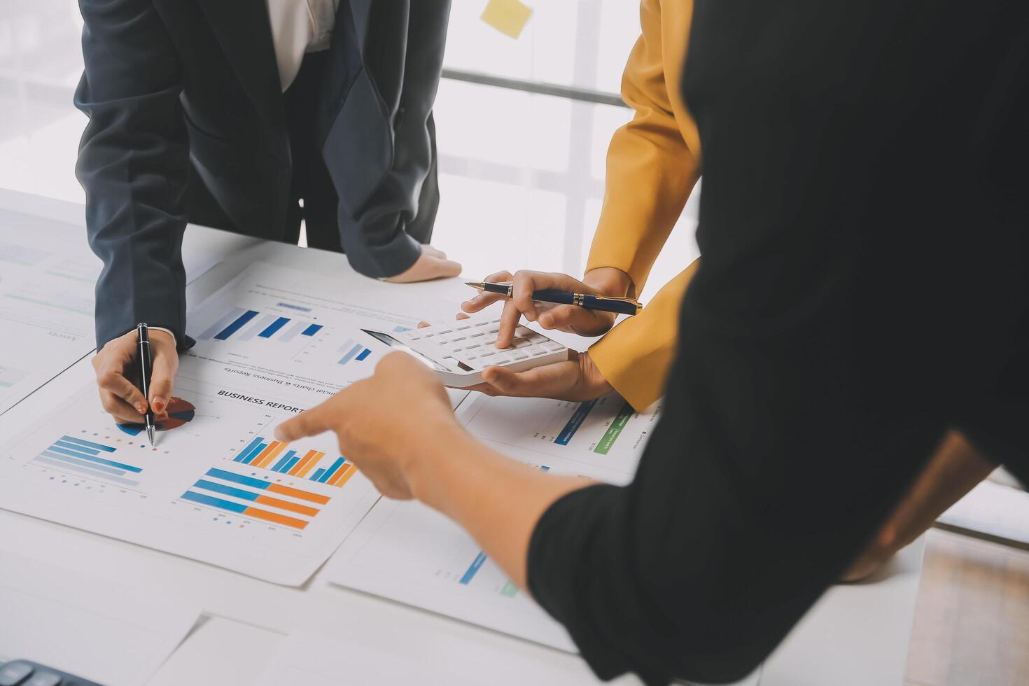 Financial analysts analyze business financial reports on a digital tablet planning investment project during a discussion at a meeting of corporate showing the results of their successful teamwork. photo