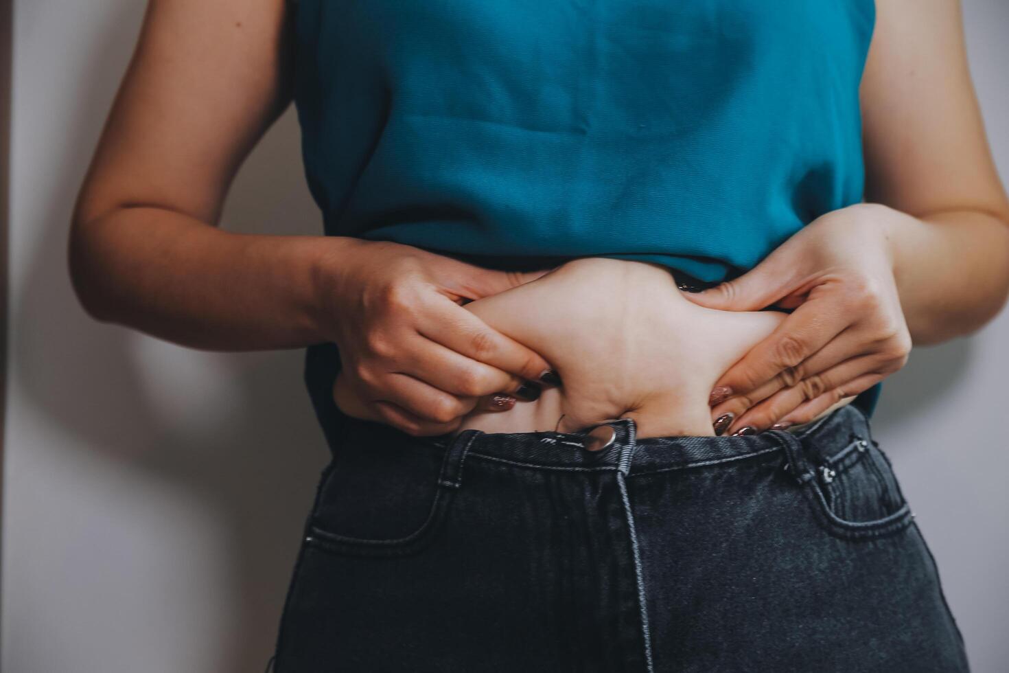 fat woman, fat belly, chubby, obese woman hand holding excessive belly fat with measure tape, woman diet lifestyle concept photo