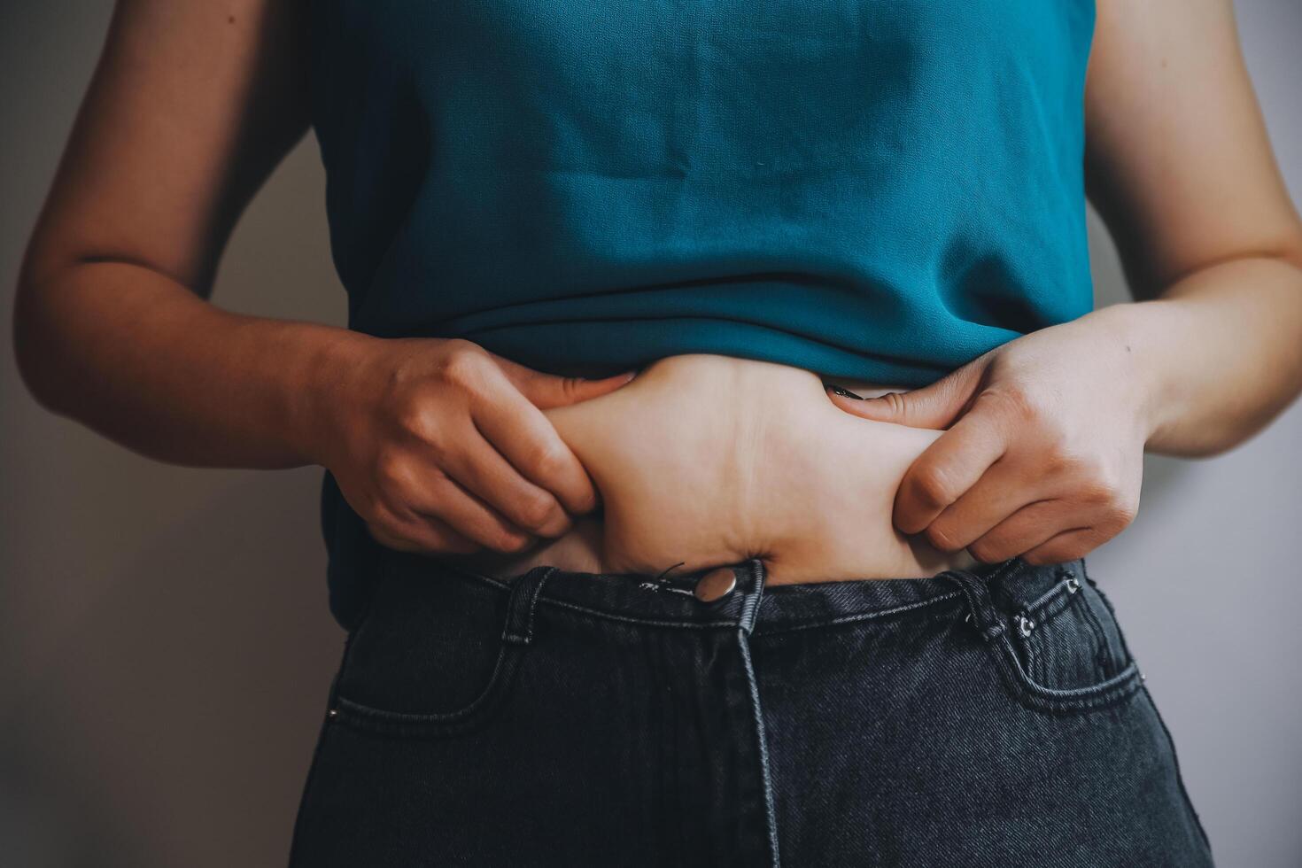 fat woman, fat belly, chubby, obese woman hand holding excessive belly fat with measure tape, woman diet lifestyle concept photo