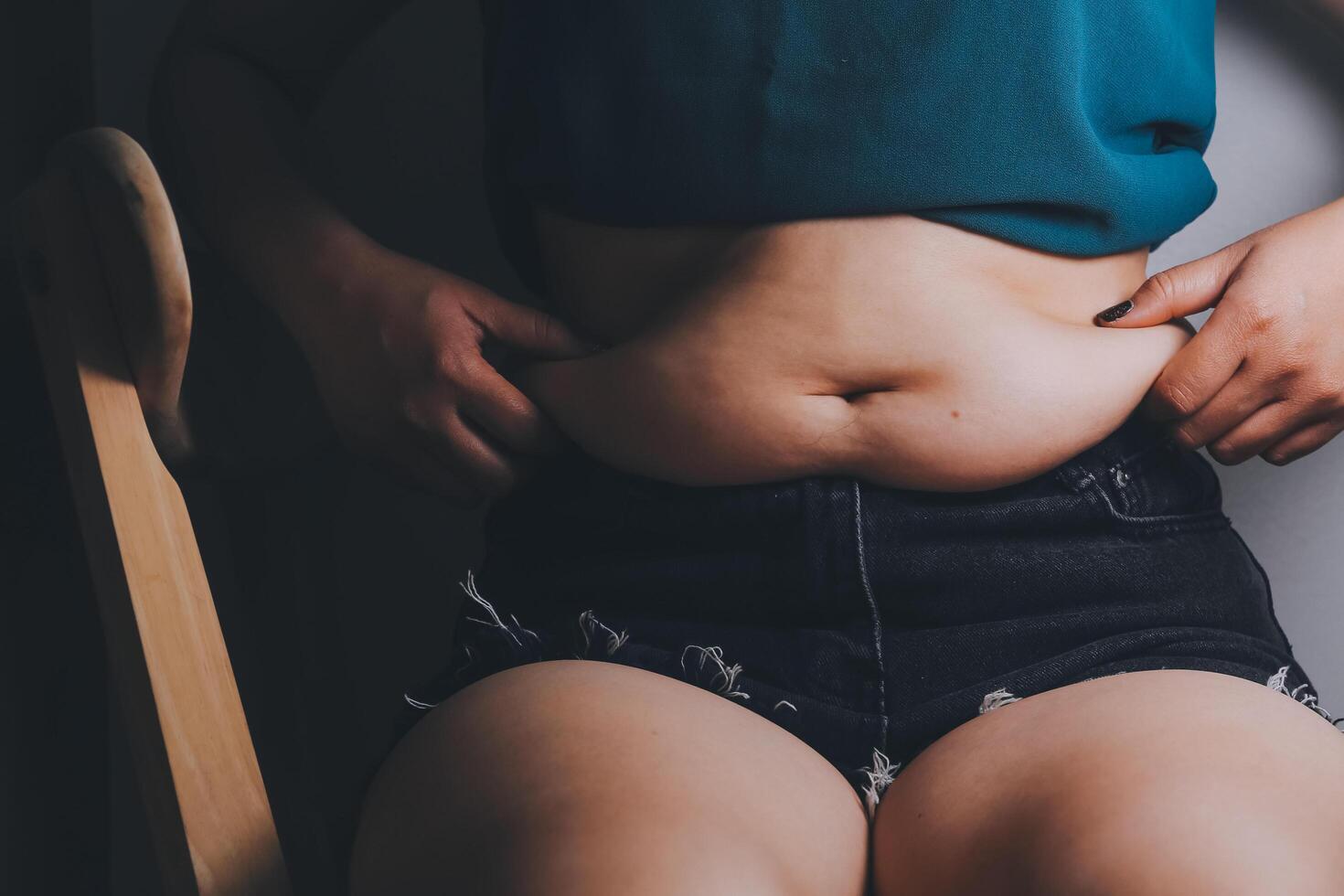 fat woman, fat belly, chubby, obese woman hand holding excessive belly fat with measure tape, woman diet lifestyle concept photo