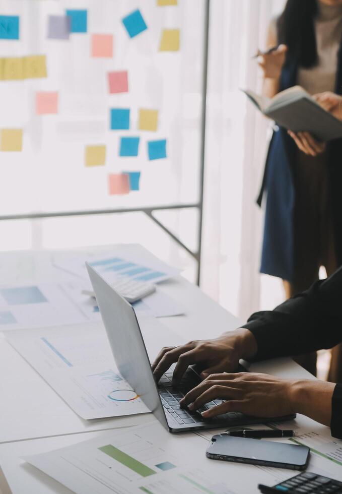 Financial analysts analyze business financial reports on a digital tablet planning investment project during a discussion at a meeting of corporate showing the results of their successful teamwork. photo