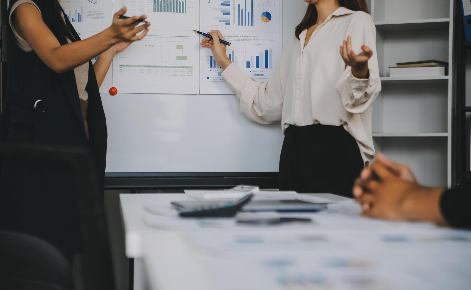 Financial analysts analyze business financial reports on a digital tablet planning investment project during a discussion at a meeting of corporate showing the results of their successful teamwork. photo