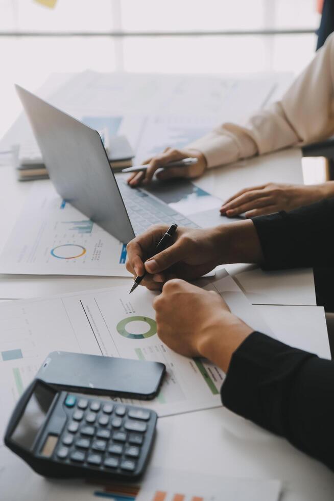Financial analysts analyze business financial reports on a digital tablet planning investment project during a discussion at a meeting of corporate showing the results of their successful teamwork. photo