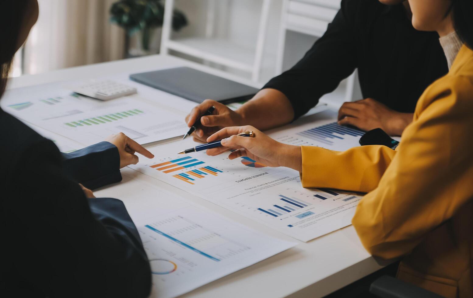 Financial analysts analyze business financial reports on a digital tablet planning investment project during a discussion at a meeting of corporate showing the results of their successful teamwork. photo
