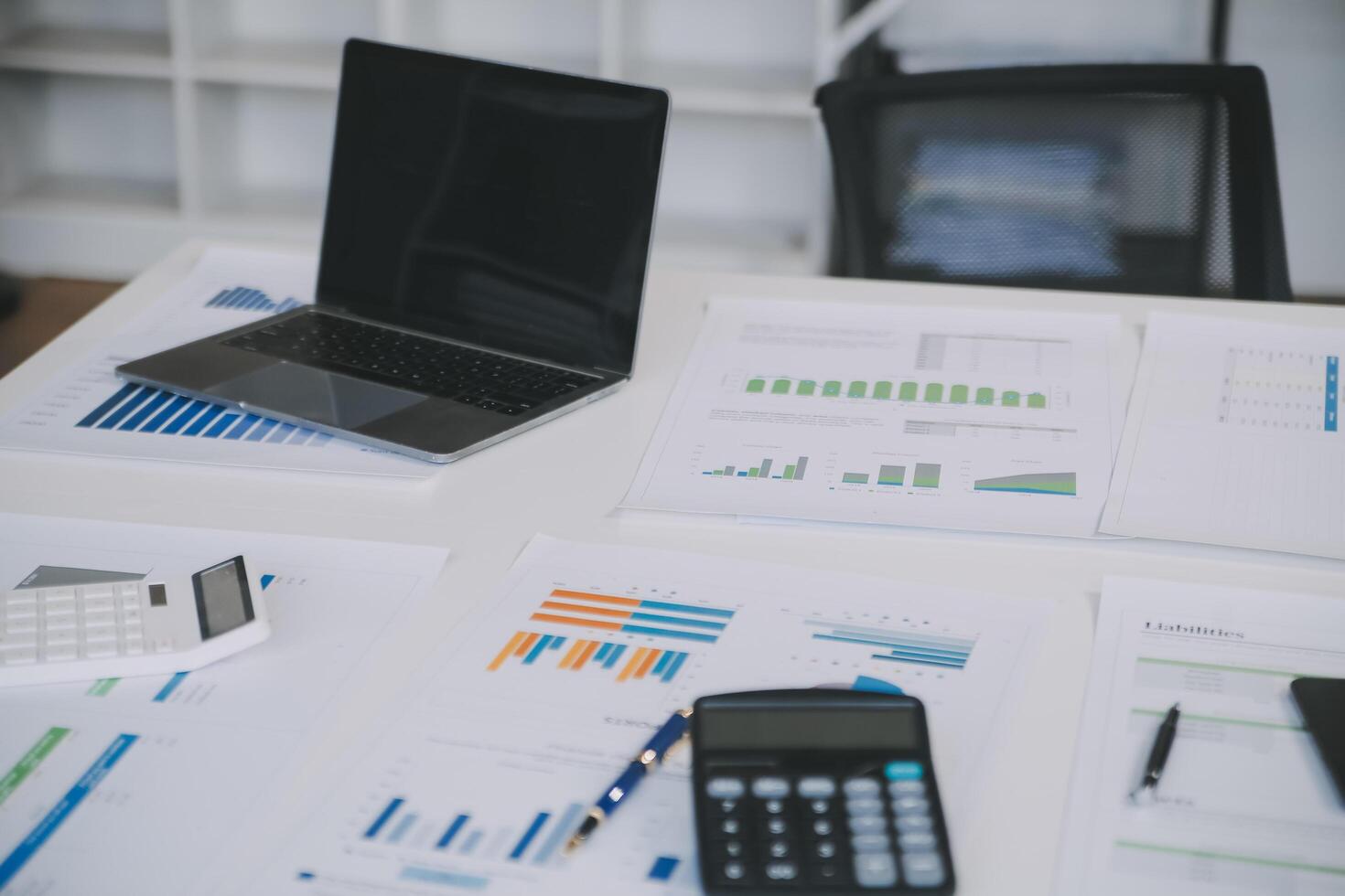 Financial analysts analyze business financial reports on a digital tablet planning investment project during a discussion at a meeting of corporate showing the results of their successful teamwork. photo