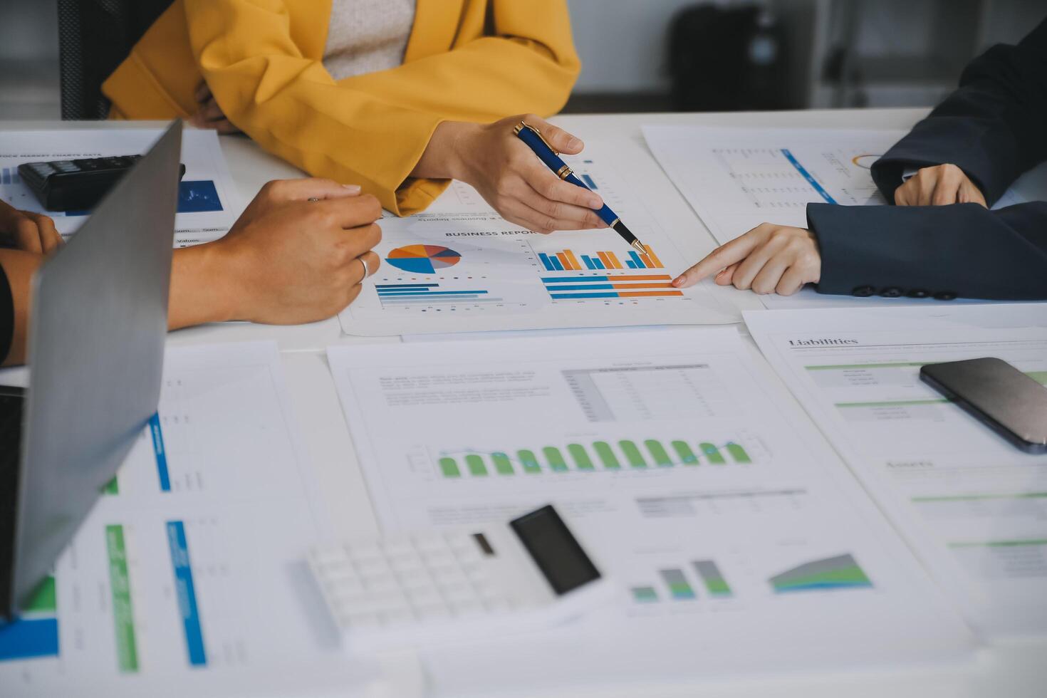 Financial analysts analyze business financial reports on a digital tablet planning investment project during a discussion at a meeting of corporate showing the results of their successful teamwork. photo