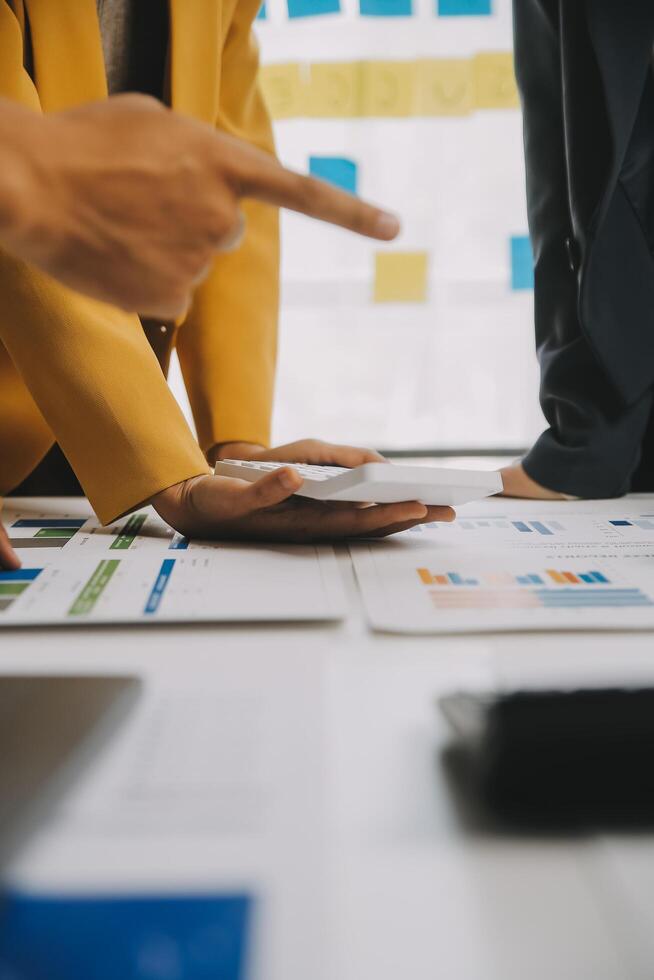 Financial analysts analyze business financial reports on a digital tablet planning investment project during a discussion at a meeting of corporate showing the results of their successful teamwork. photo
