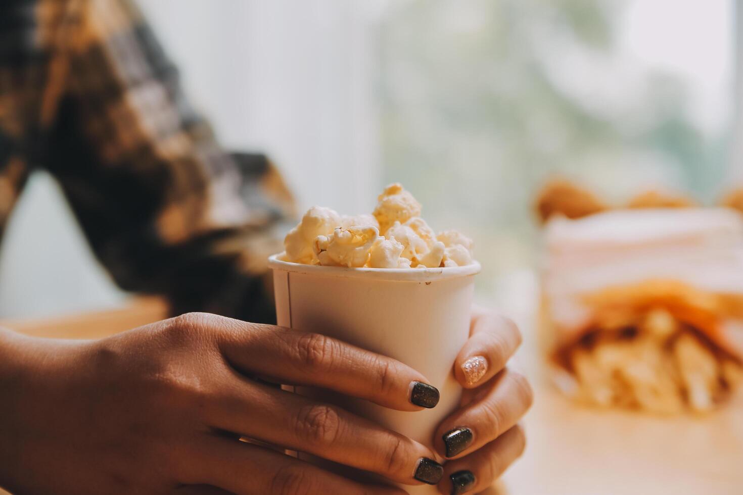 A woman holding a bowl of popcorn photo
