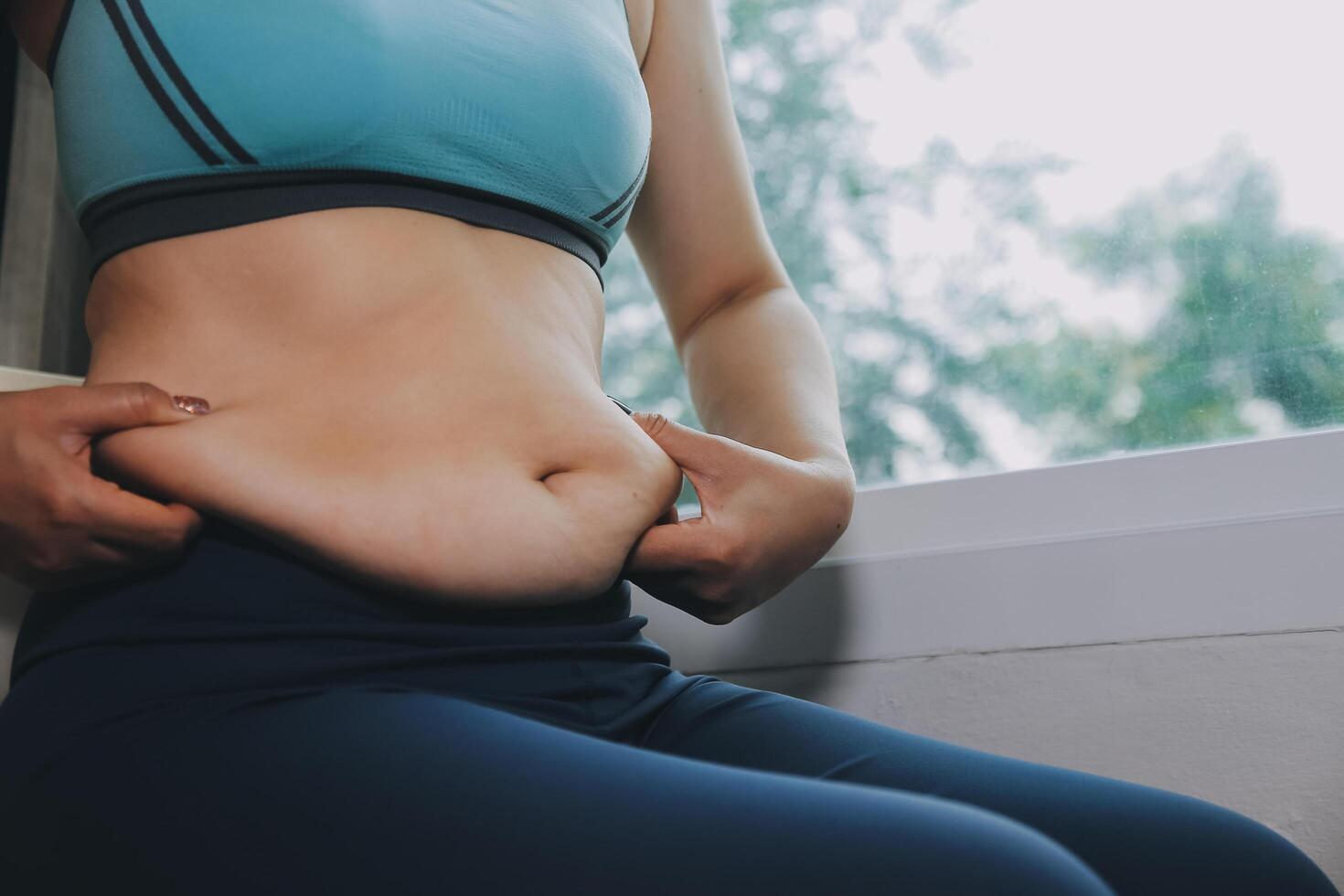 fat woman, fat belly, chubby, obese woman hand holding excessive belly fat with measure tape, woman diet lifestyle concept photo