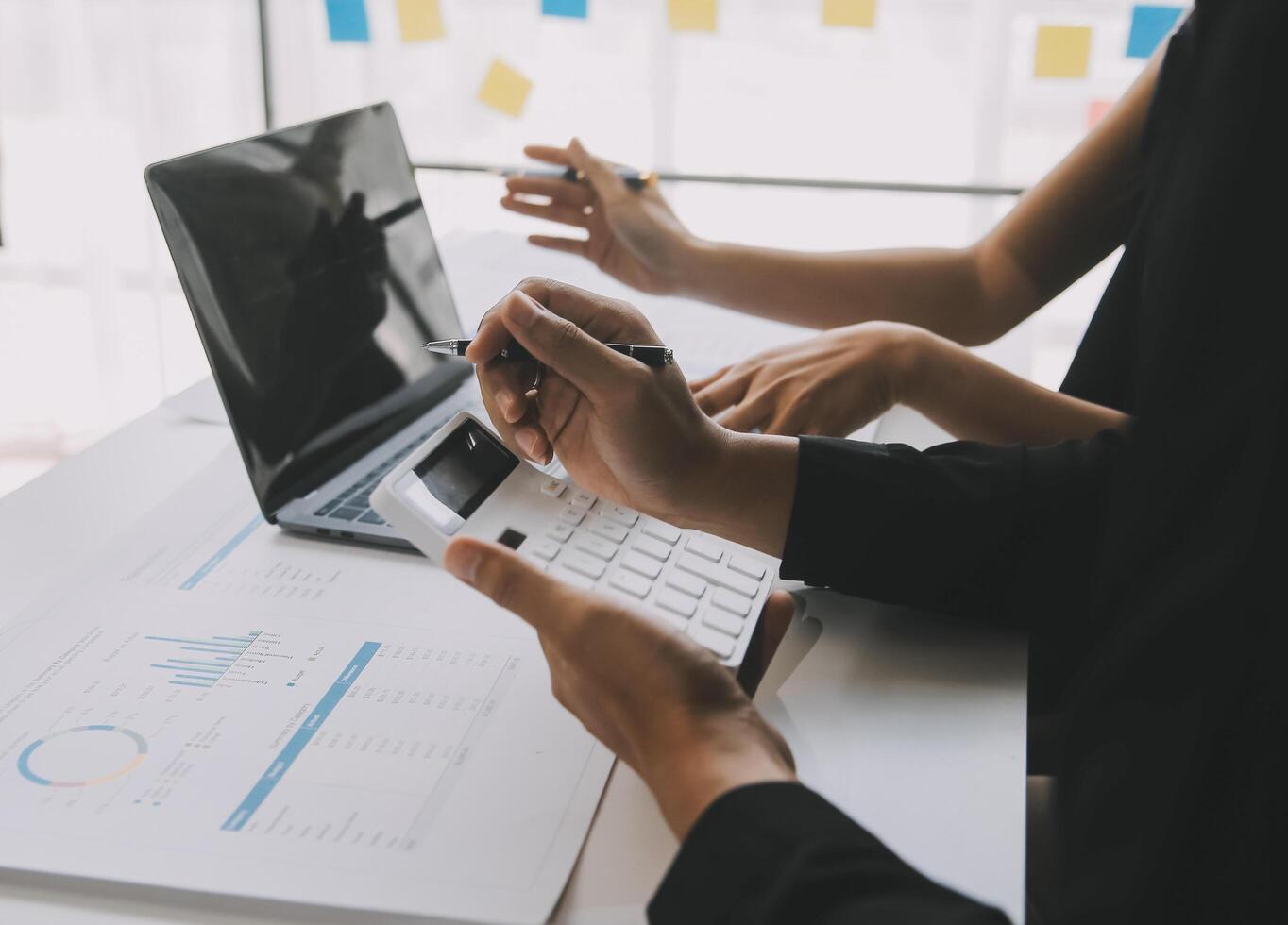 Financial analysts analyze business financial reports on a digital tablet planning investment project during a discussion at a meeting of corporate showing the results of their successful teamwork. photo