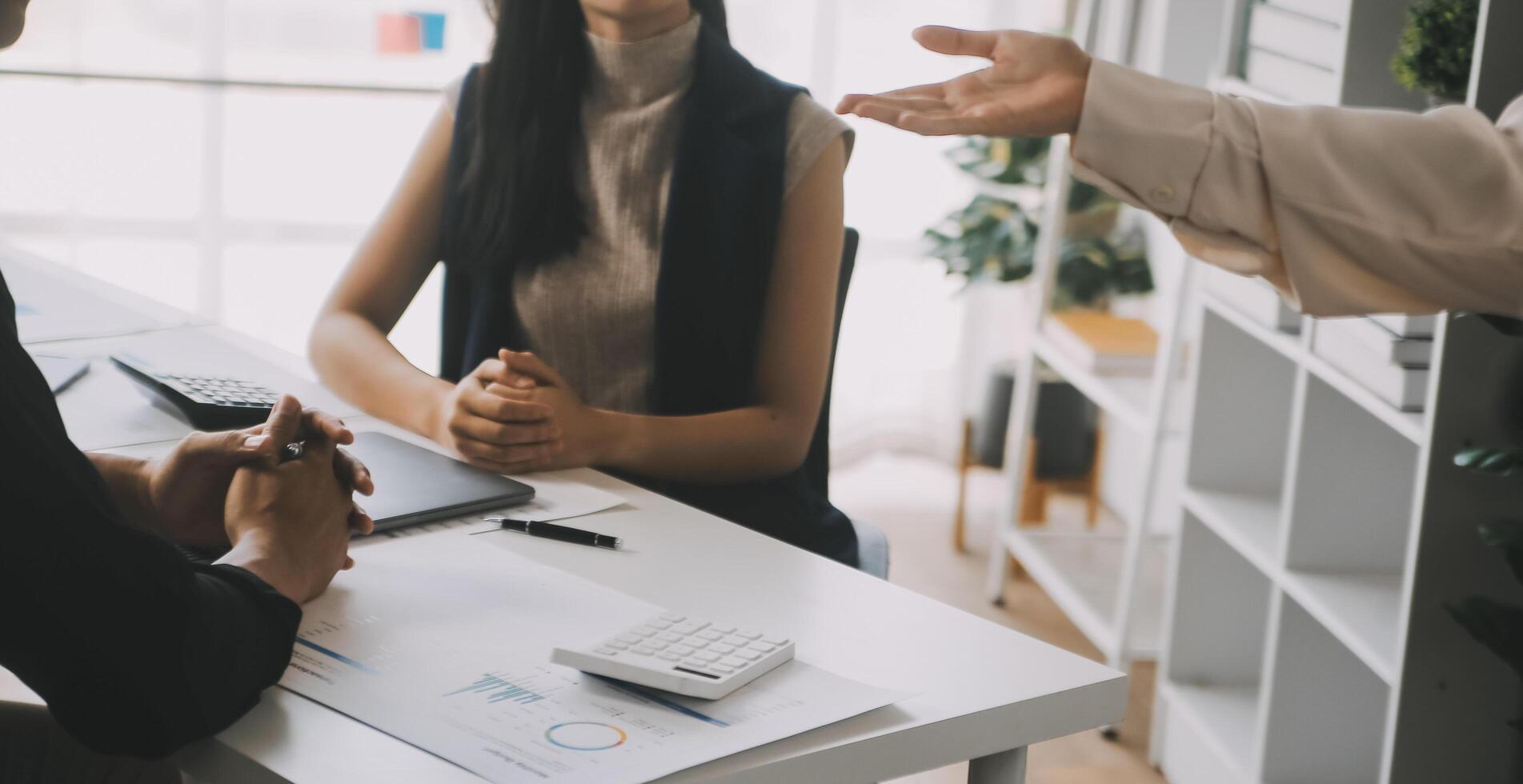 Financial analysts analyze business financial reports on a digital tablet planning investment project during a discussion at a meeting of corporate showing the results of their successful teamwork. photo