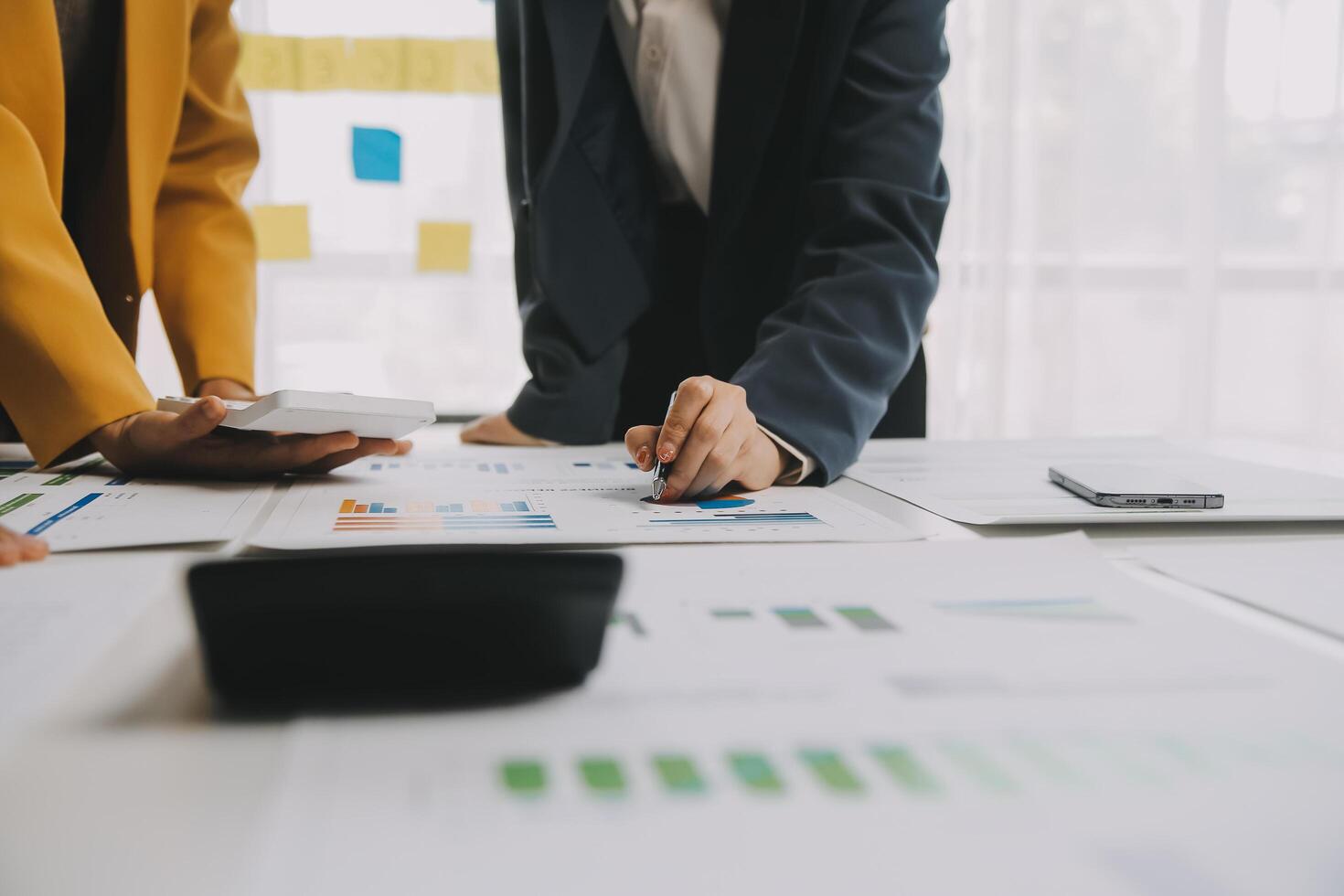 Financial analysts analyze business financial reports on a digital tablet planning investment project during a discussion at a meeting of corporate showing the results of their successful teamwork. photo