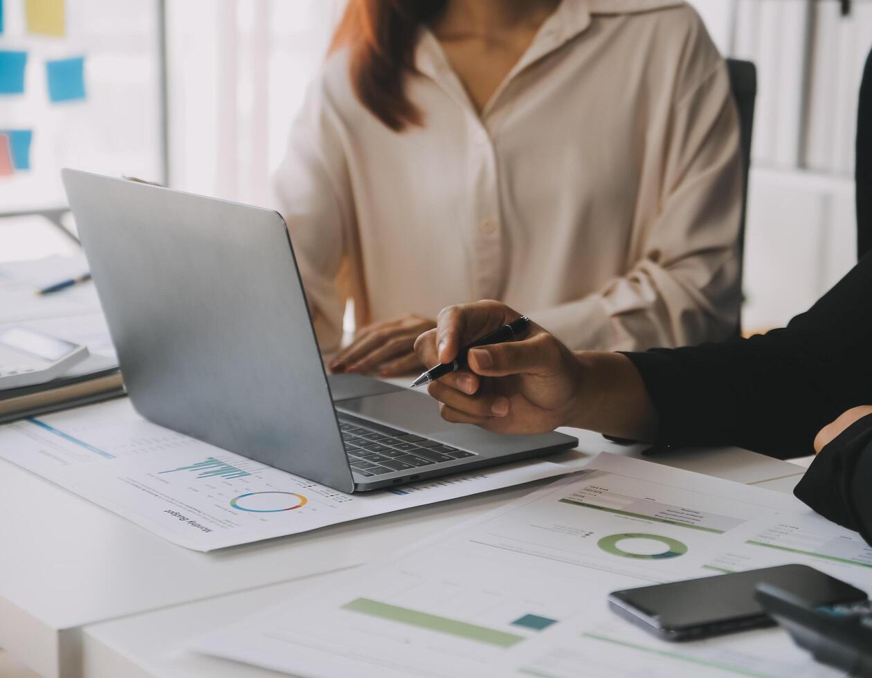 Financial analysts analyze business financial reports on a digital tablet planning investment project during a discussion at a meeting of corporate showing the results of their successful teamwork. photo