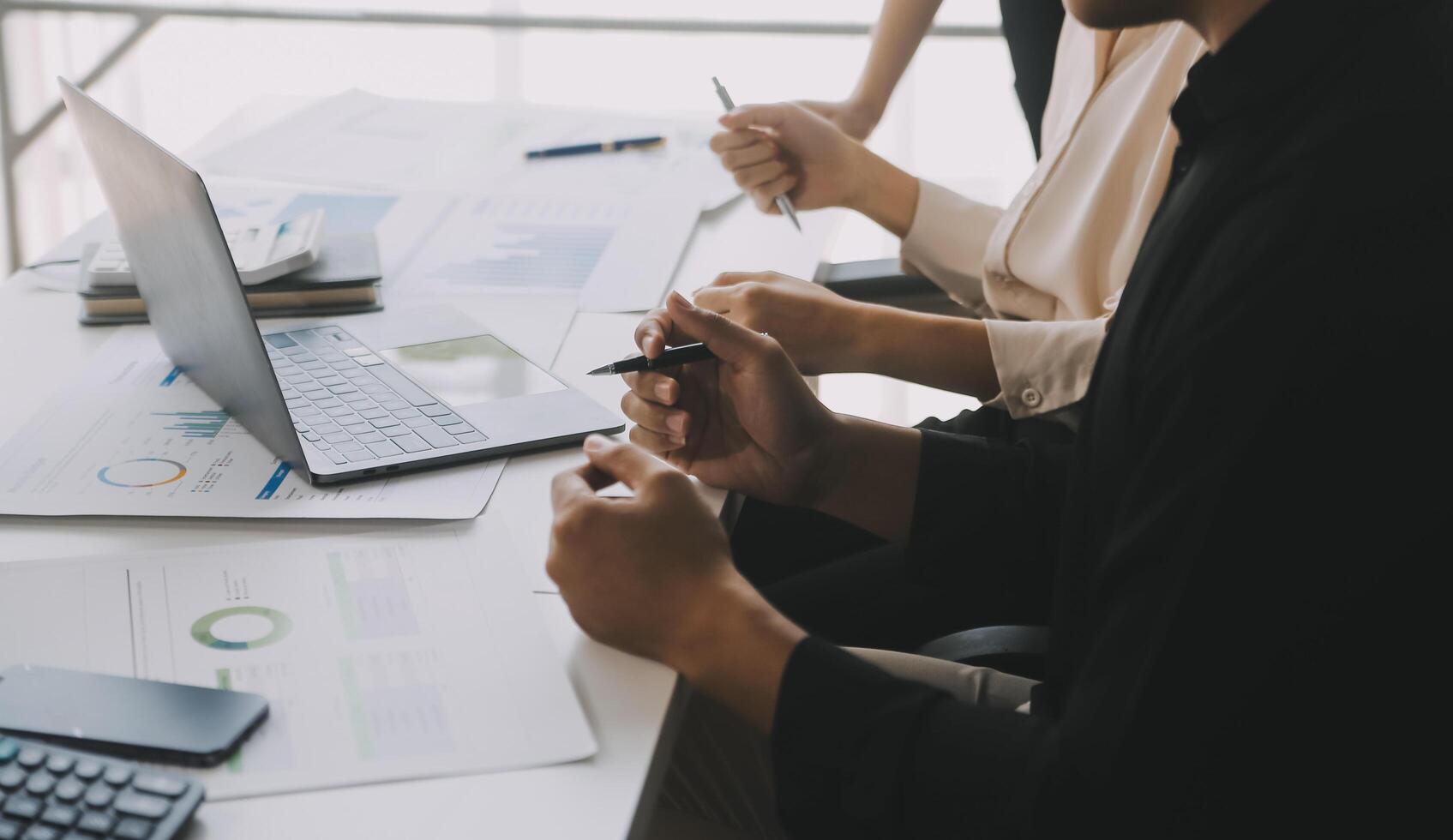Financial analysts analyze business financial reports on a digital tablet planning investment project during a discussion at a meeting of corporate showing the results of their successful teamwork. photo