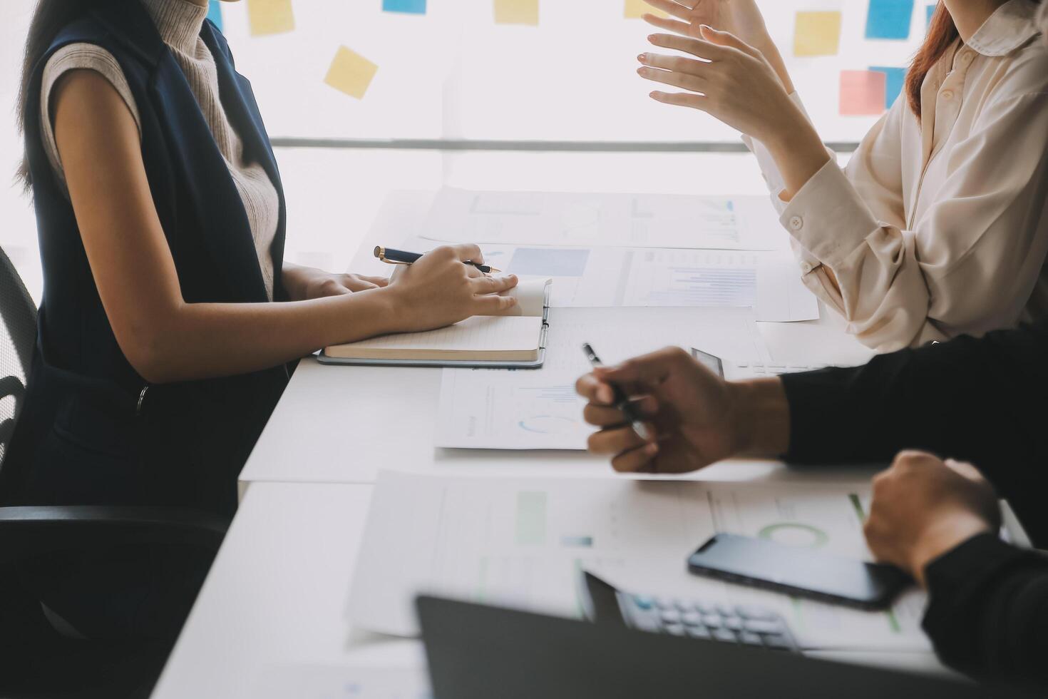 Financial analysts analyze business financial reports on a digital tablet planning investment project during a discussion at a meeting of corporate showing the results of their successful teamwork. photo