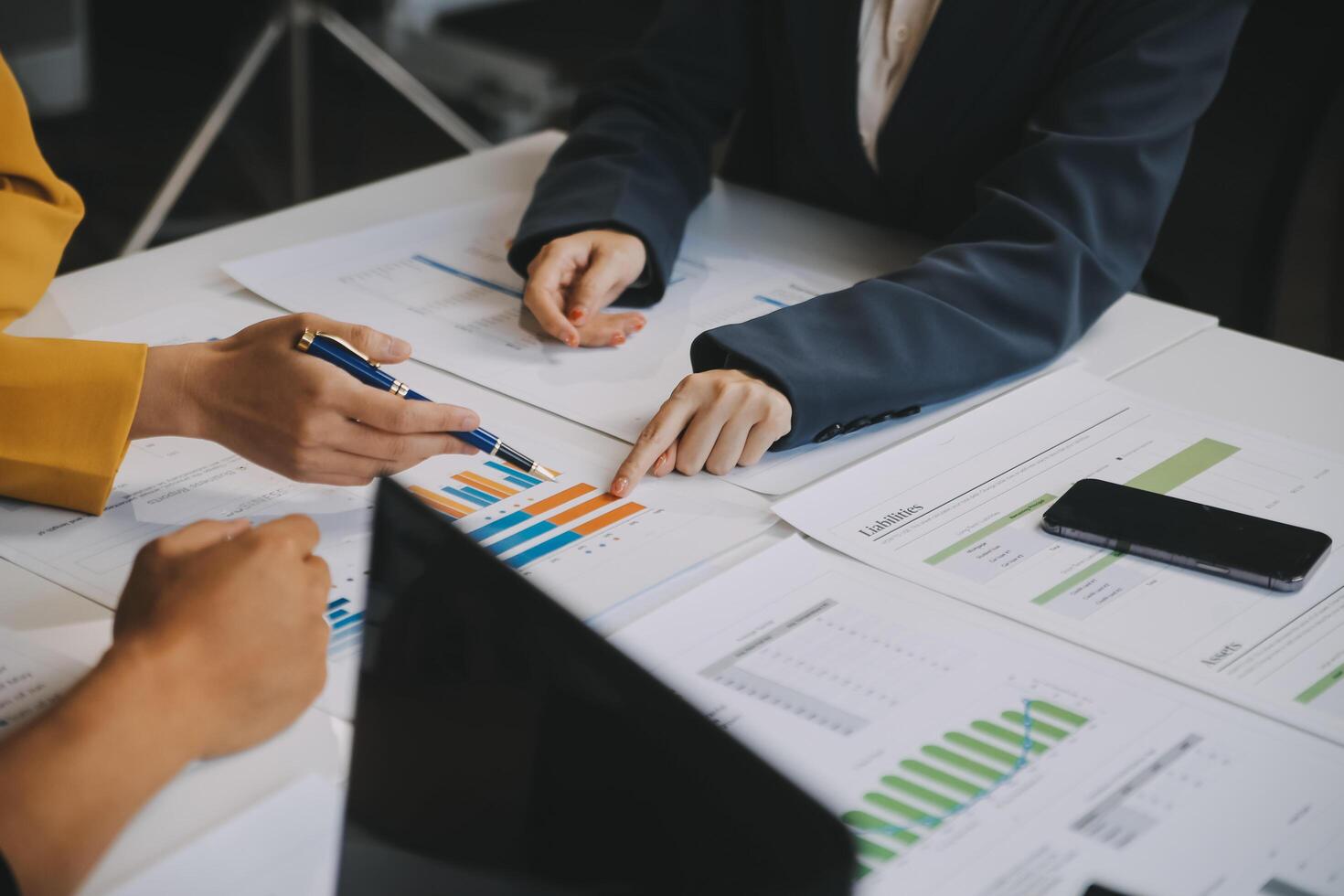Financial analysts analyze business financial reports on a digital tablet planning investment project during a discussion at a meeting of corporate showing the results of their successful teamwork. photo