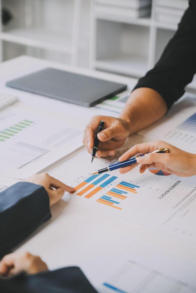Financial analysts analyze business financial reports on a digital tablet planning investment project during a discussion at a meeting of corporate showing the results of their successful teamwork. photo
