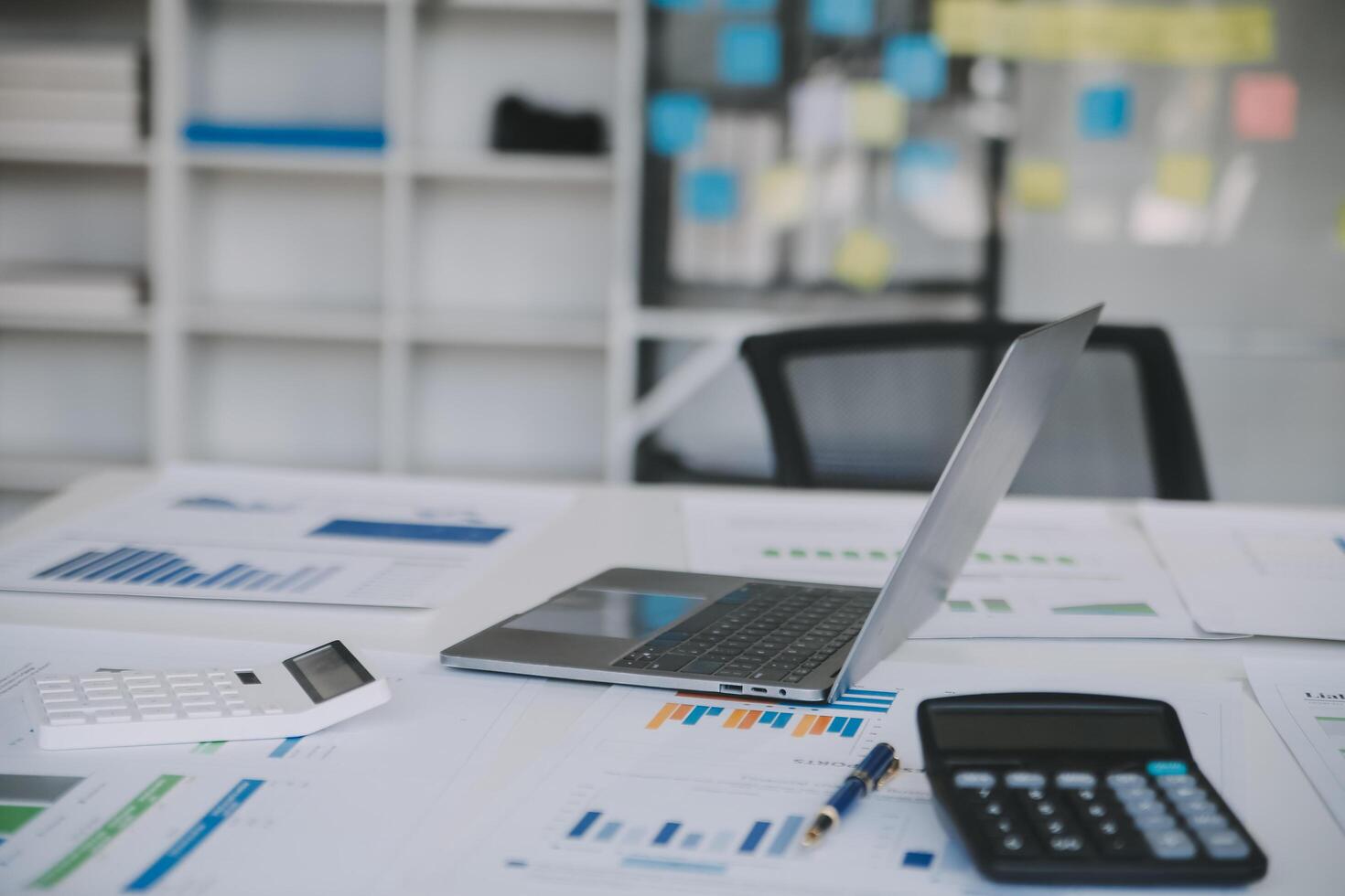 Financial analysts analyze business financial reports on a digital tablet planning investment project during a discussion at a meeting of corporate showing the results of their successful teamwork. photo
