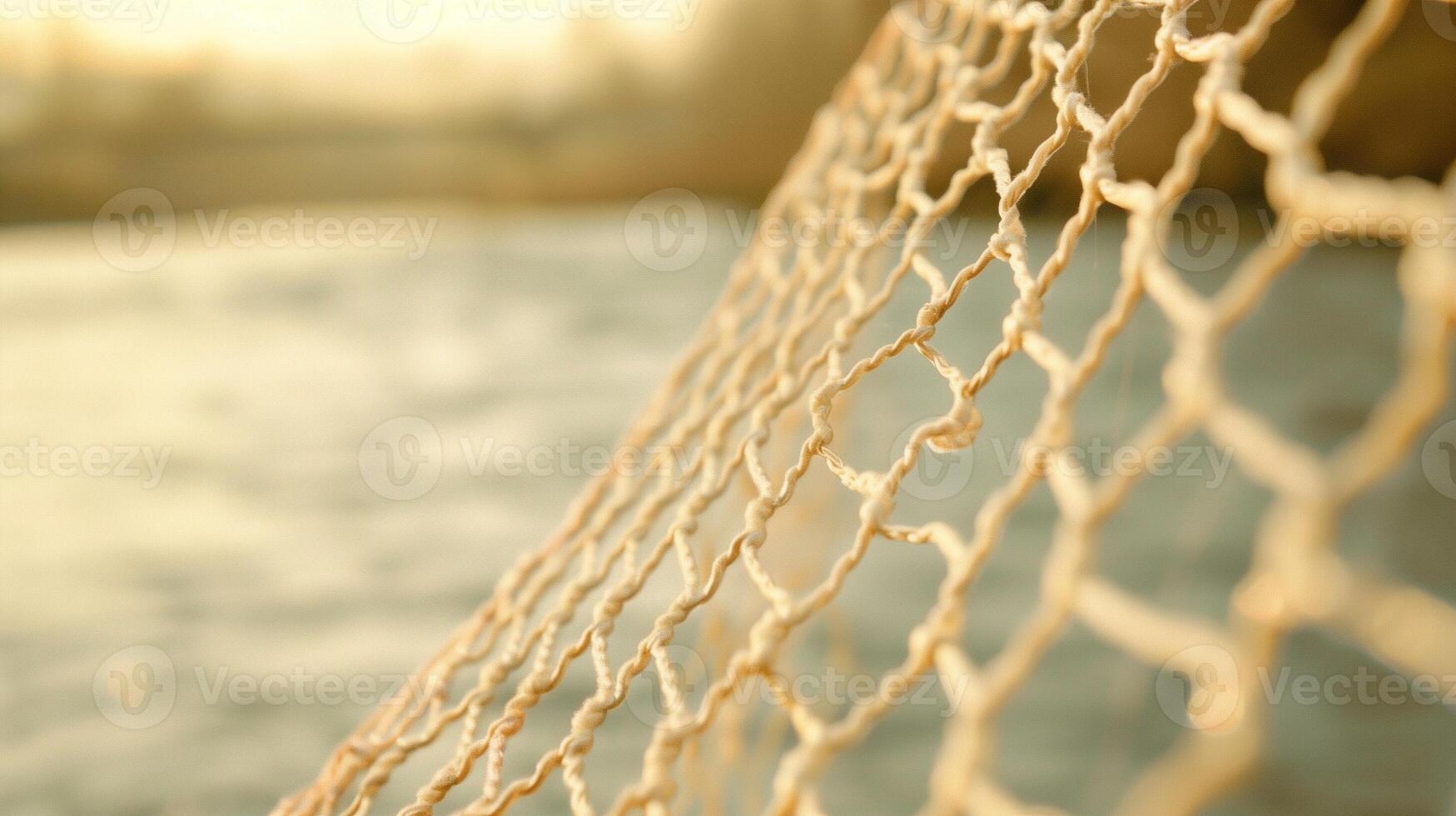 Rope Netting with Sunlit Ocean Background, Nautical Theme, Fishing Net Close-Up, Warm Tones, Outdoors, Tranquil Coastal Scene at Sunset, Blurred Background, Soft Focus, Marine Texture photo