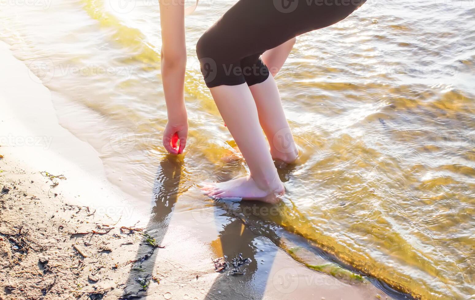 Child's bare feet walking at a beach. photo