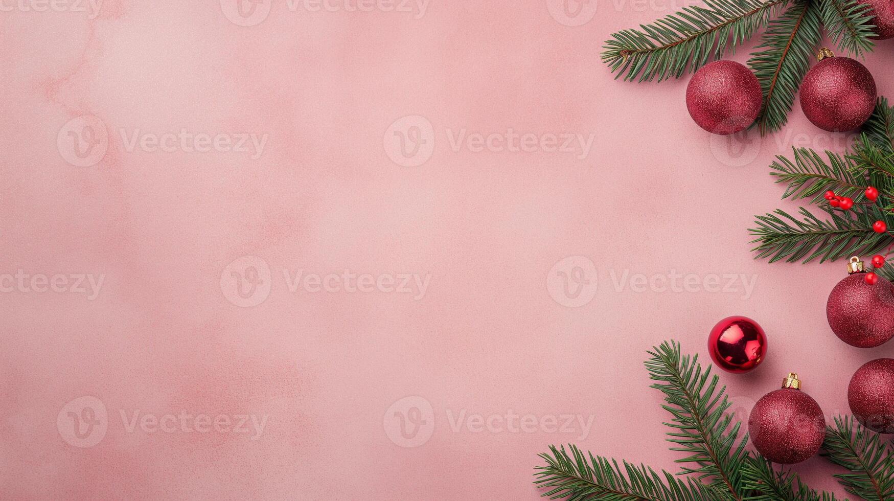 Festive Christmas Background with Red and Gold Holiday Ornaments and Green Pine Branches on a Pink Surface photo
