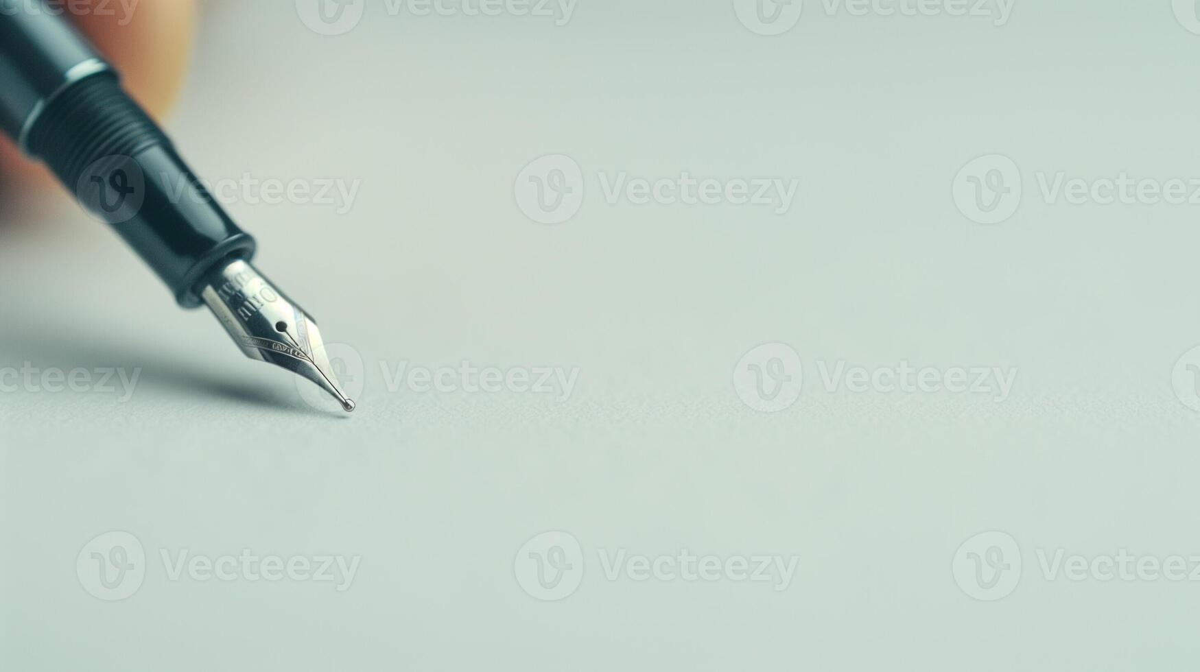 Close-Up of Fountain Pen Tip on Blank Paper for Writing Stationery or Business Concept photo