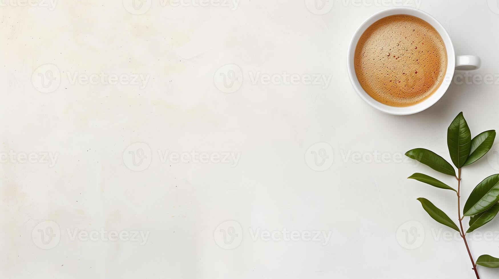 Top view of a cup of coffee and a leaf on a white background photo