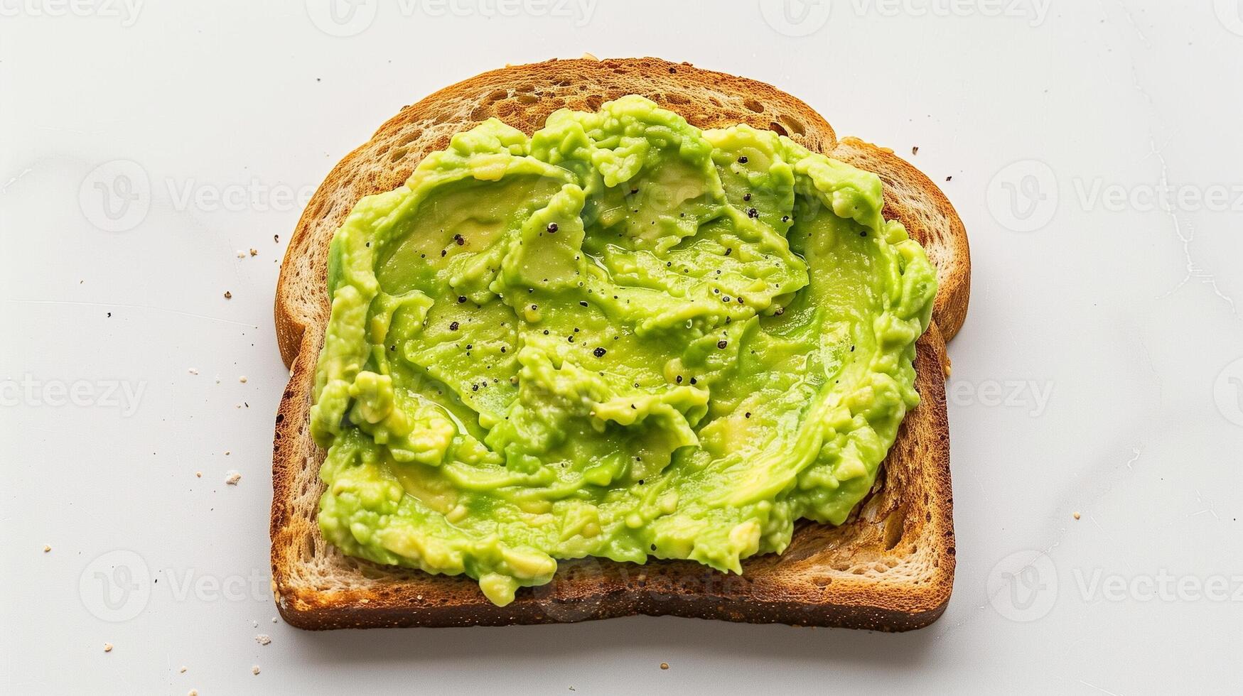 Single Slice of Toast with Creamy Mashed Avocado on Clean White Background for Healthy Breakfast or Snack Concept photo