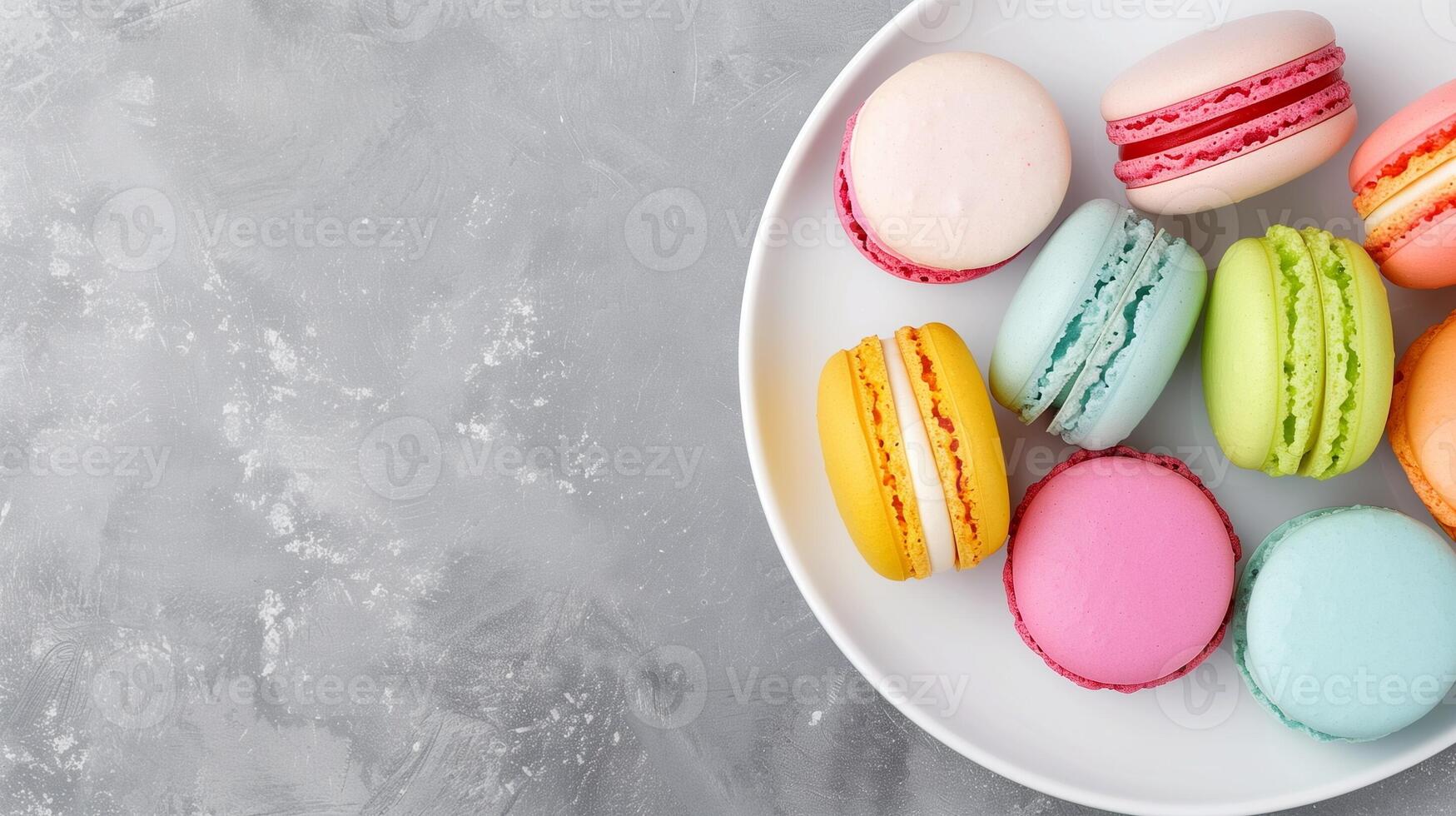Overhead View of Colorful Macarons on White Plate Against Gray Textured Background Dessert, Confectionery Themes, and French Bakery Concepts in Food Photography, Still Life and Minimalist Design photo