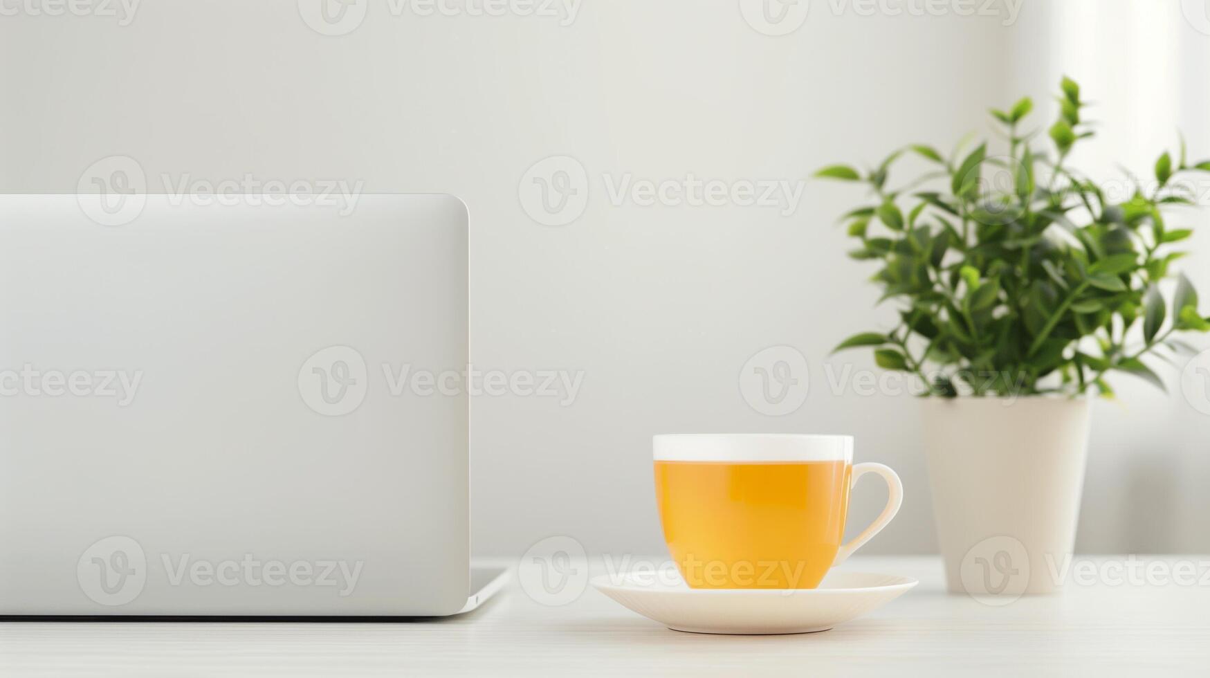 Modern Organized Workspace with Laptop, Cup of Tea, and Green Plant on Minimalist Desk in Bright Room, Ideal for Productivity or Relaxation, Clean Design Great for Home Office or Business Setting photo