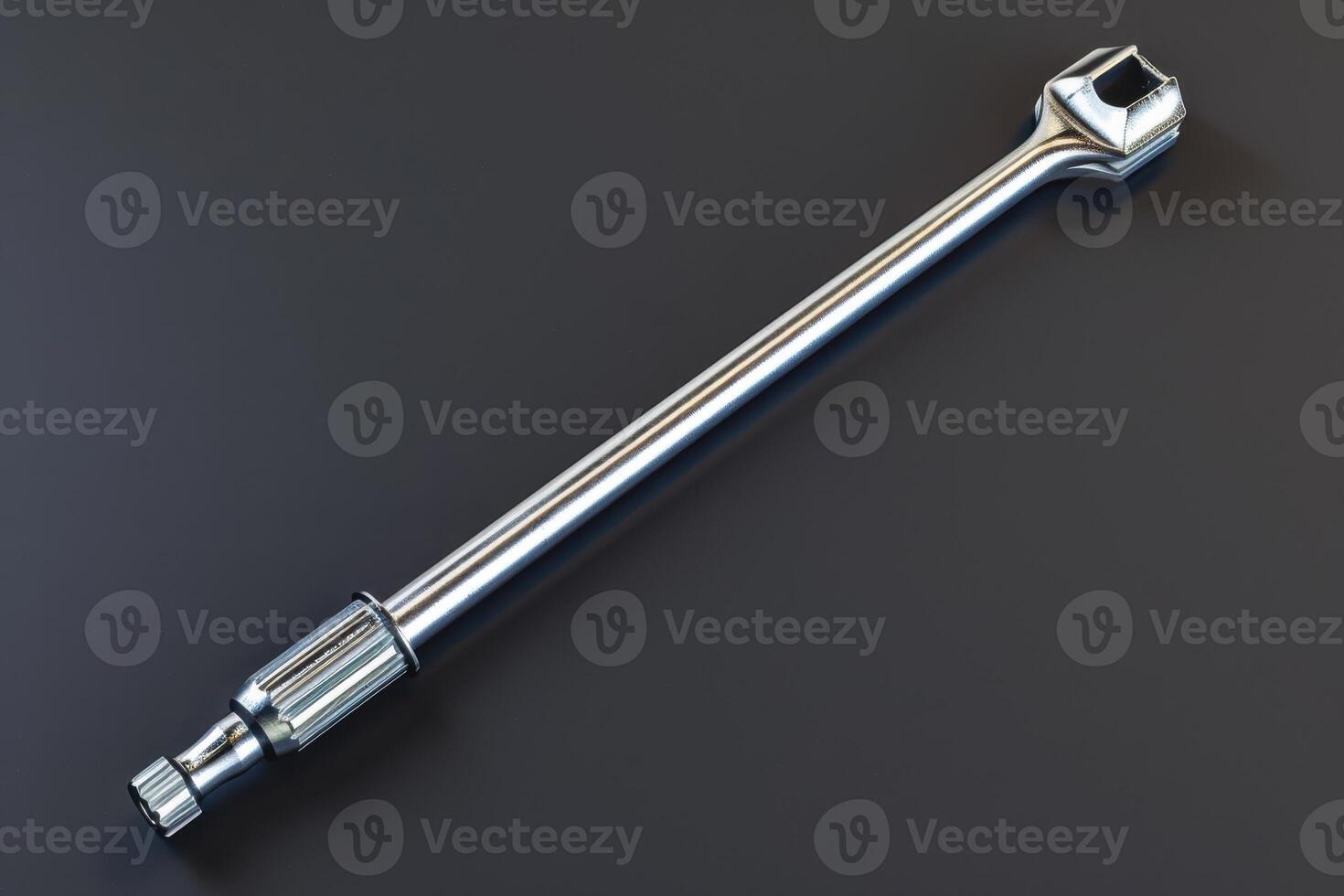 Shiny metal wrench on a dark background with a smooth surface photo