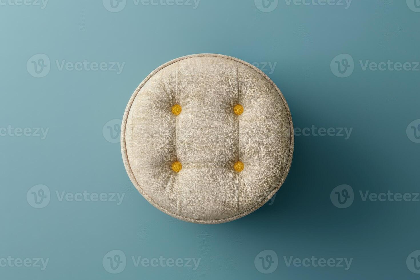 Round tufted stool on a light blue background with yellow buttons photo