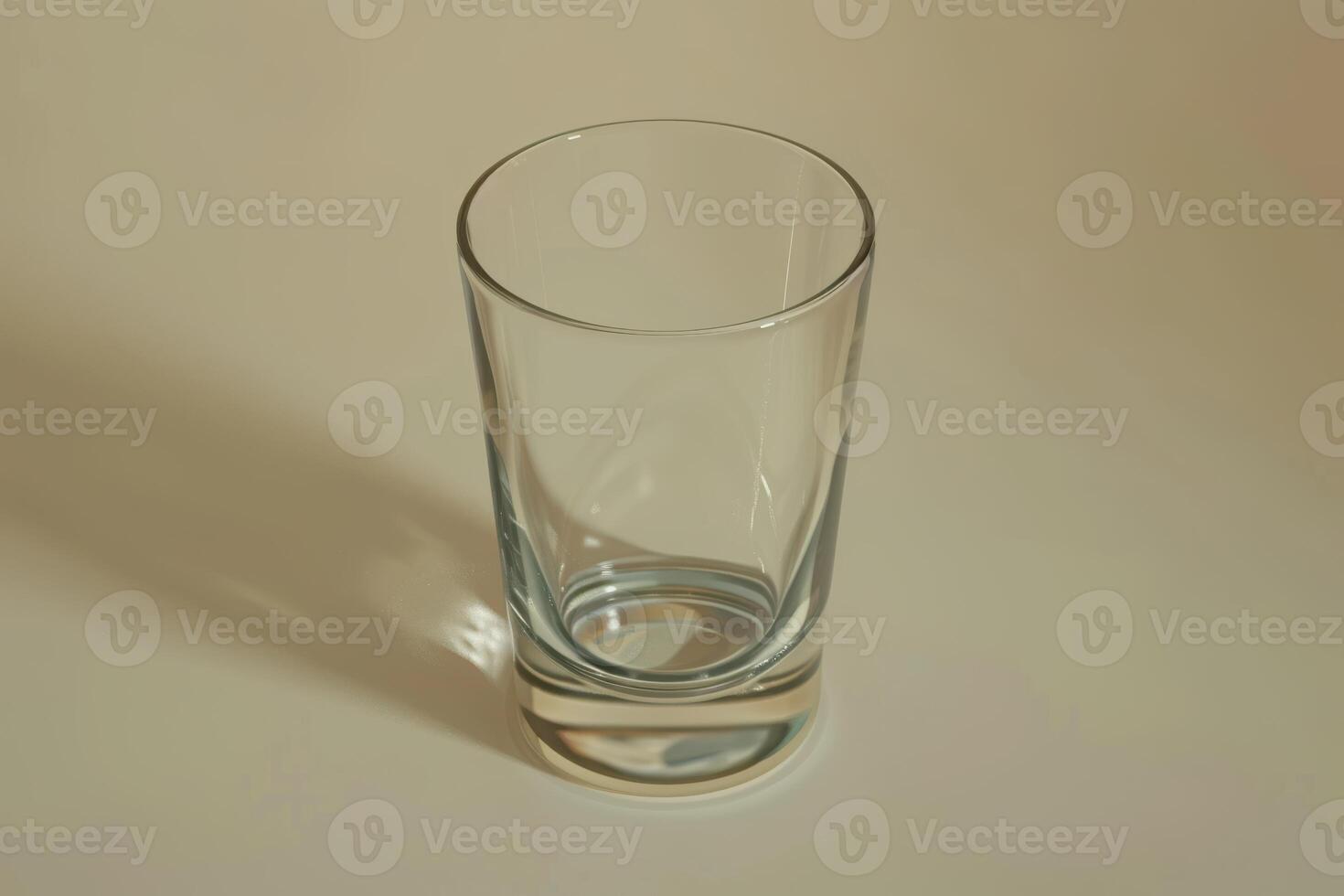 Empty glass on a smooth surface with soft lighting photo