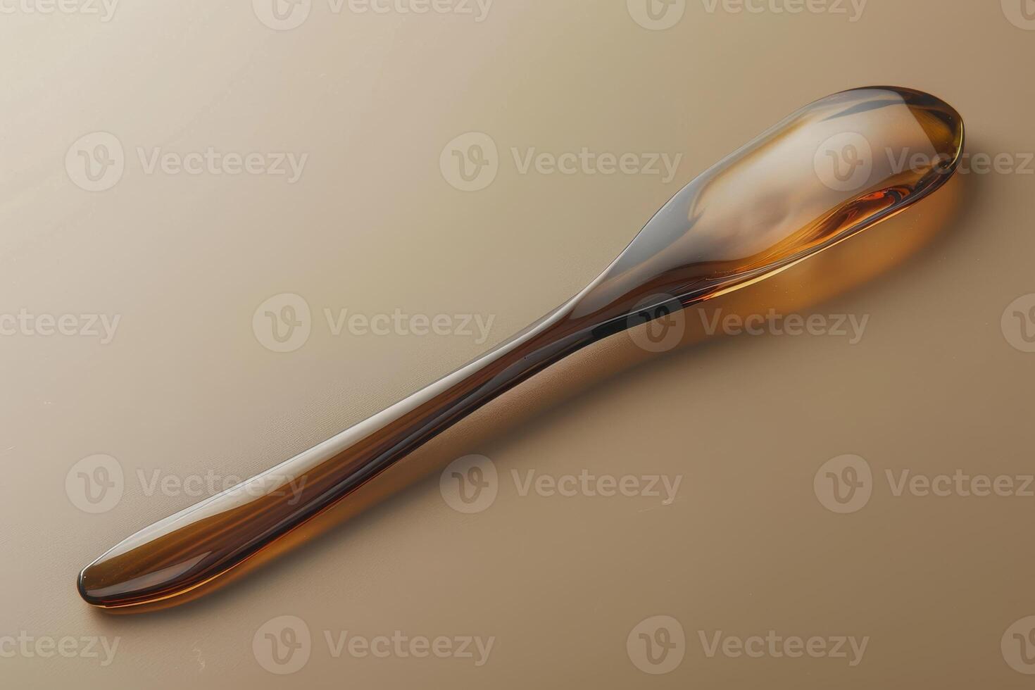 Elegant amber spoon resting on a smooth surface with soft lighting photo