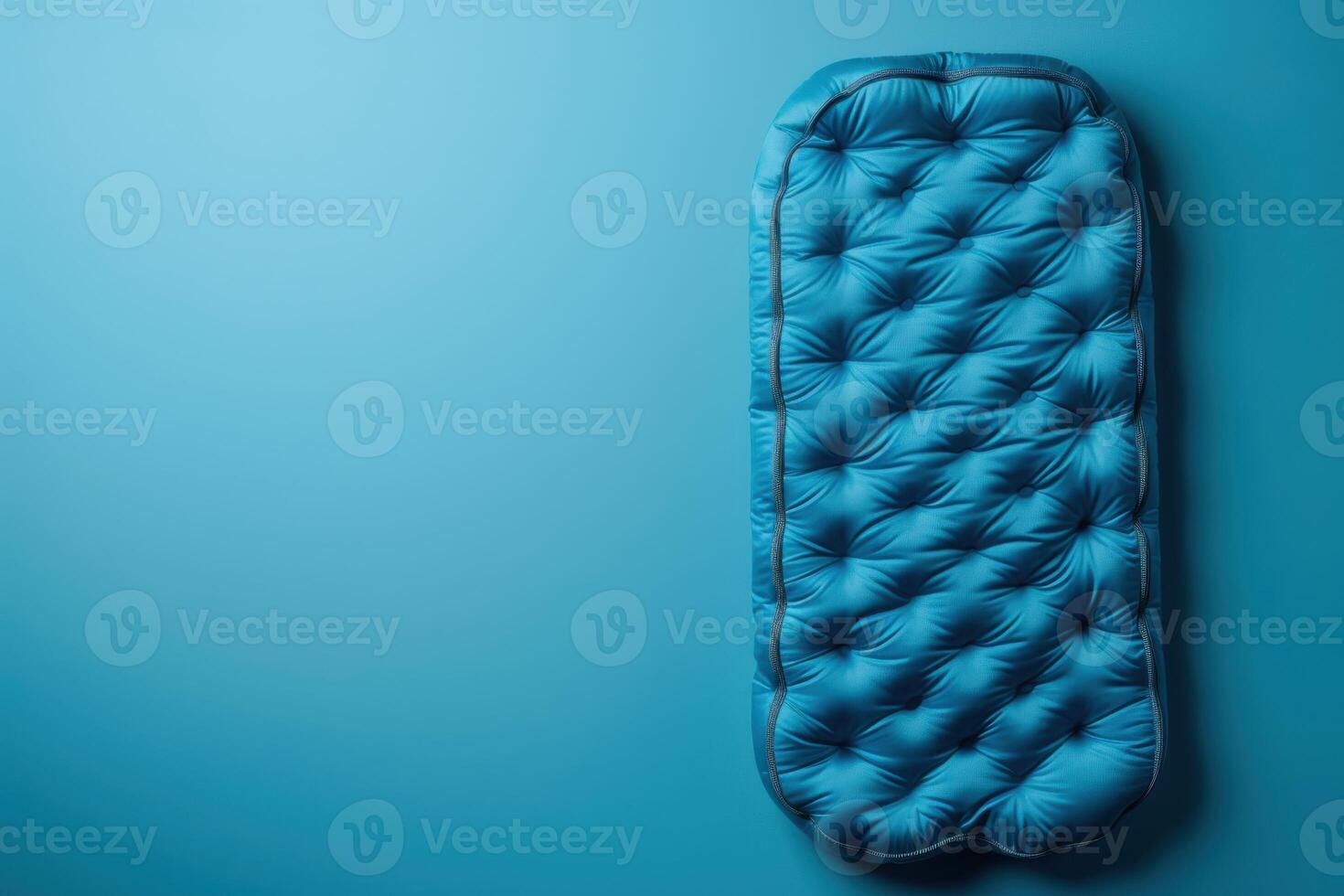A vibrant blue camping mat displayed against a matching background photo
