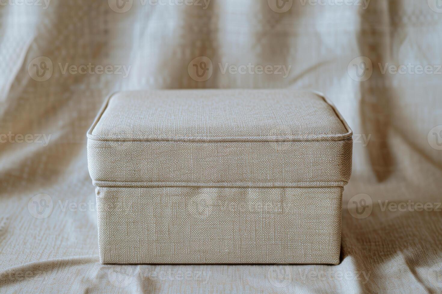 Simple linen storage box placed on a soft fabric background in natural light photo