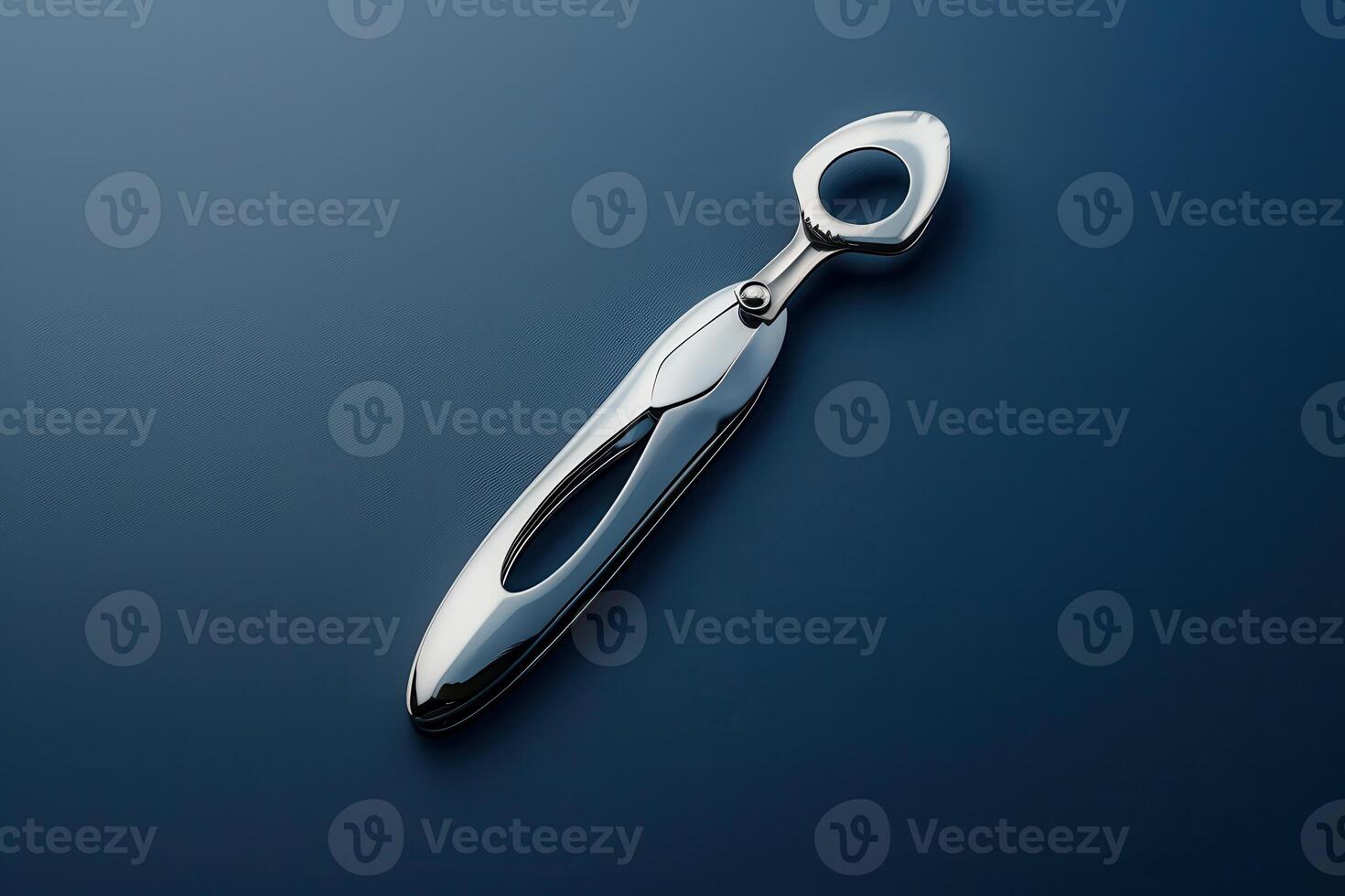 Elegant silver bottle opener on a dark background featuring a modern design photo