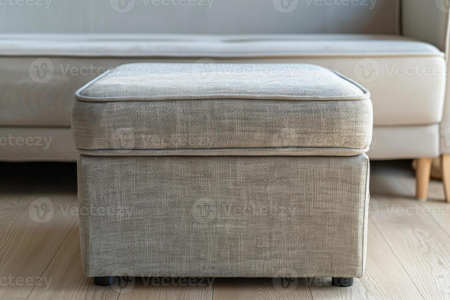 Modern upholstered ottoman in a cozy living room with a light-colored couch photo